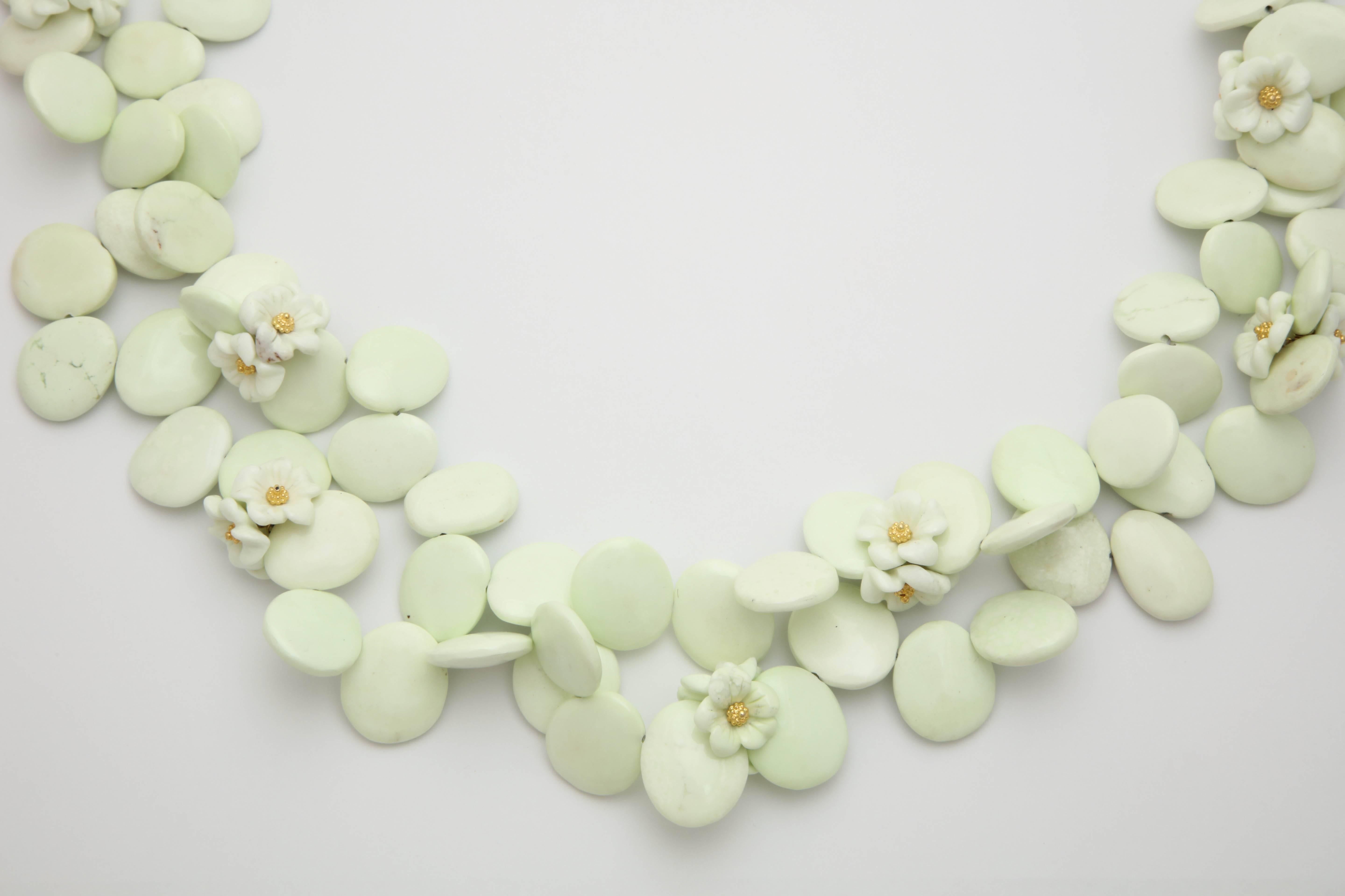 A pair of Lemon Chrysophrase Necklaces. The necklaces are composed of lemon chrysophrase petals and flower beads. The center of each flower has an 18kt yellow gold flower bead. The clasps are 18kt yellow gold.
Length: 39.00 inches
Width: .75 inch