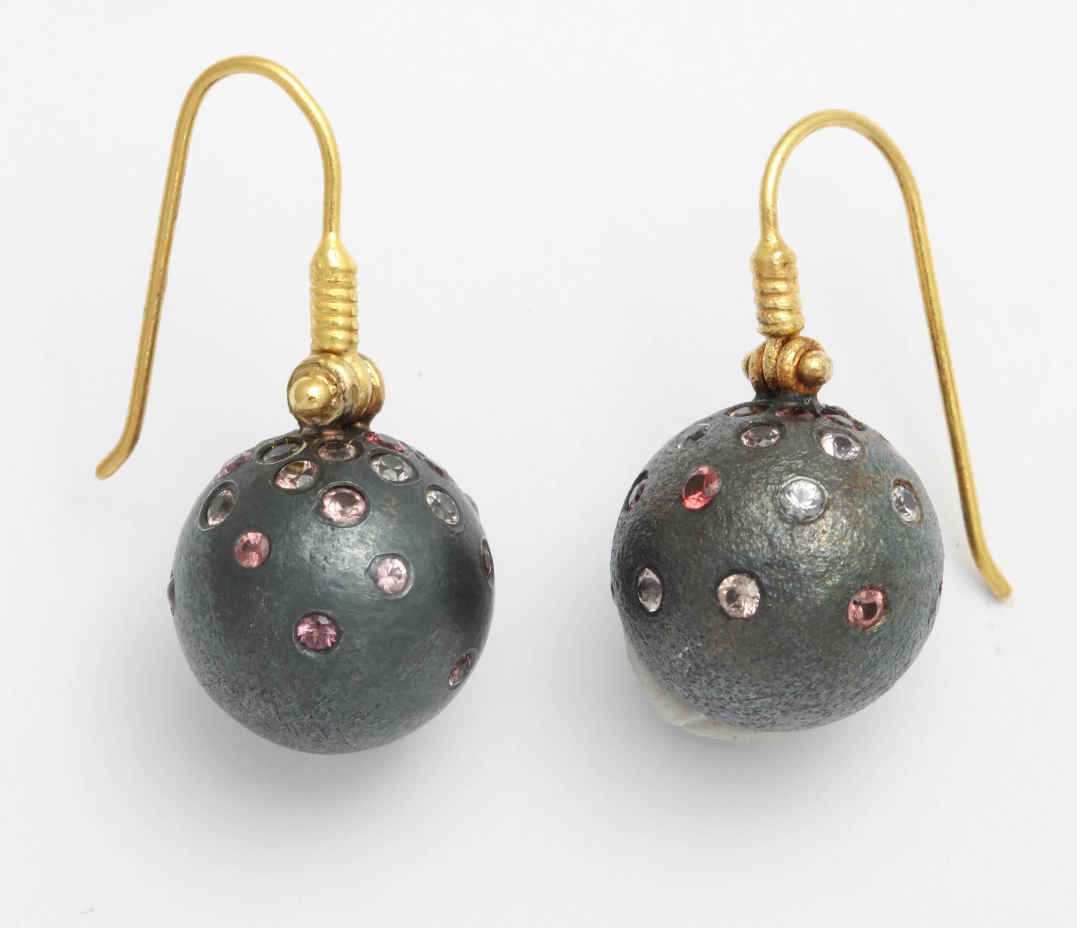 A pair of rhodium plated sterling silver ball earrings set with multi colored spinel The balls are suspended from 18kt yellow gold ear wires with hinges.
There are approximately 2.08cts of spinel
Length: 1.10 inches
Width: .60 inch