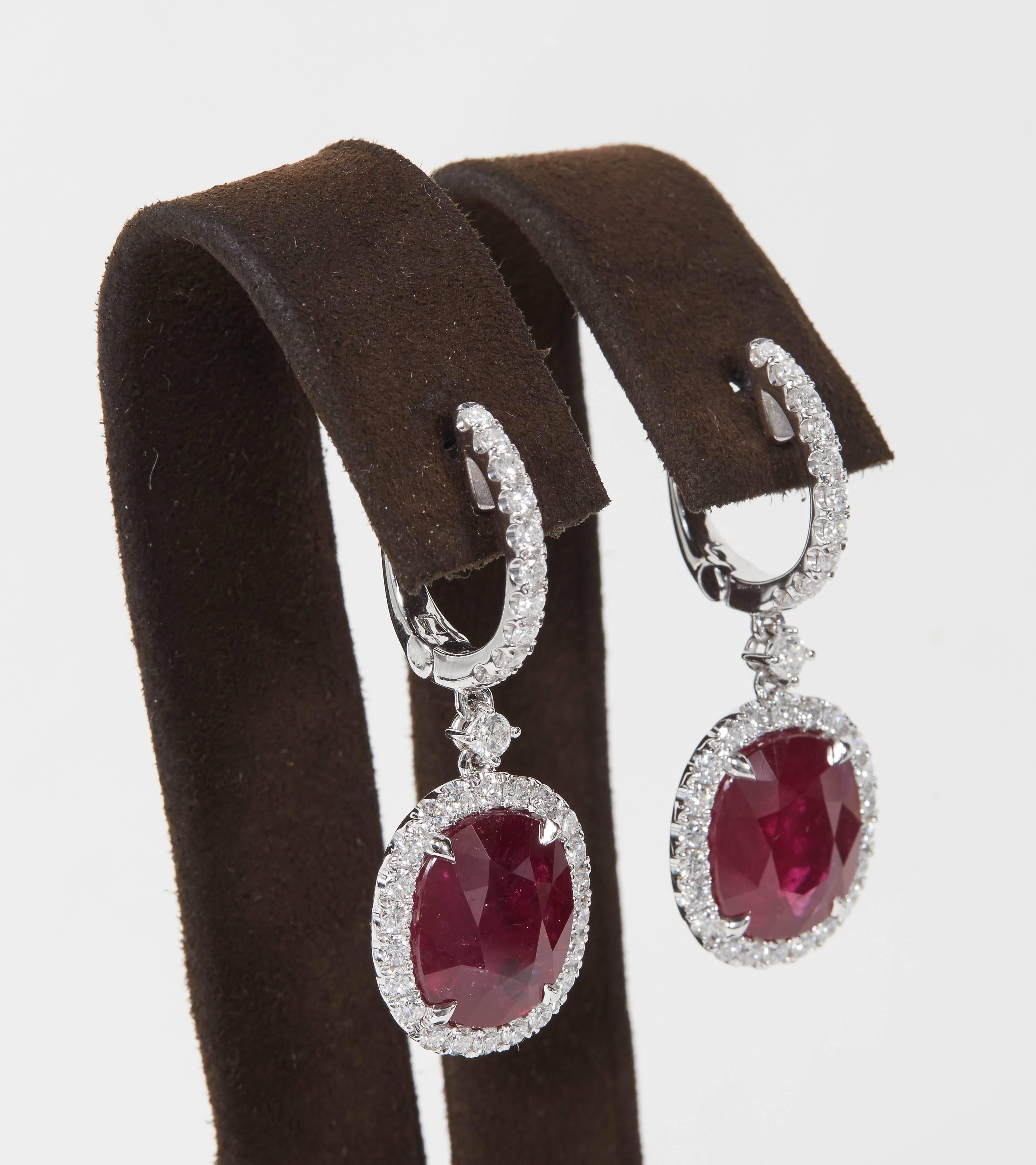 

A beautiful Ruby and Diamond earring set in a wearable design. 

13.70 carats of Fine Red Ruby (certified by GIA) set with 1.85 carats of round brilliant cut white diamonds. 

18k white gold.

Approximately 2 inches in length from the highest to