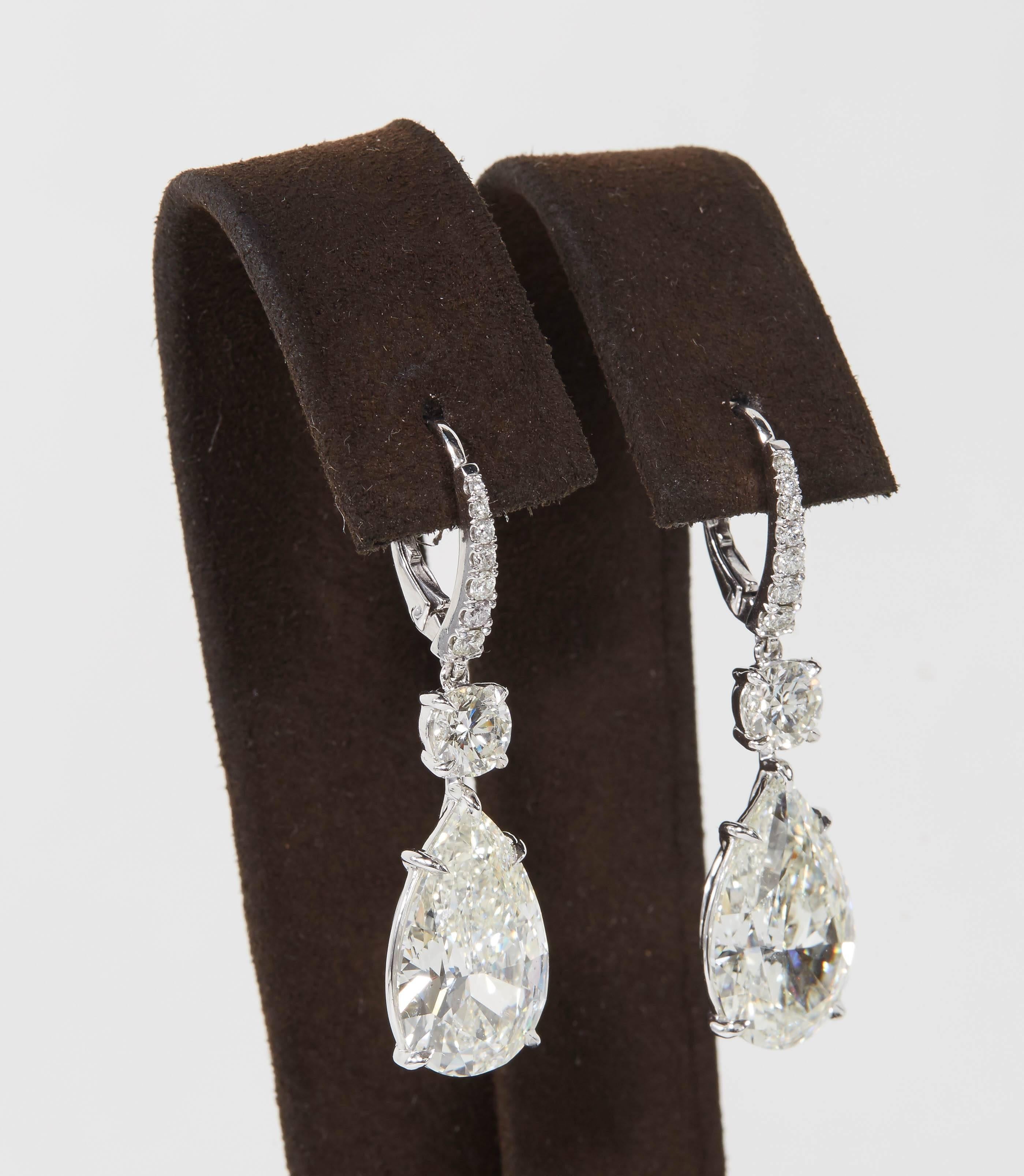 

An INCREDIBLE pair of earrings!!

A beautiful matching pair of GIA certified pear shape diamonds J color SI1 and J SI2.

The pear shaped diamond drops weigh over 6 carats each but have a much larger look, the total carat weight of the two pear
