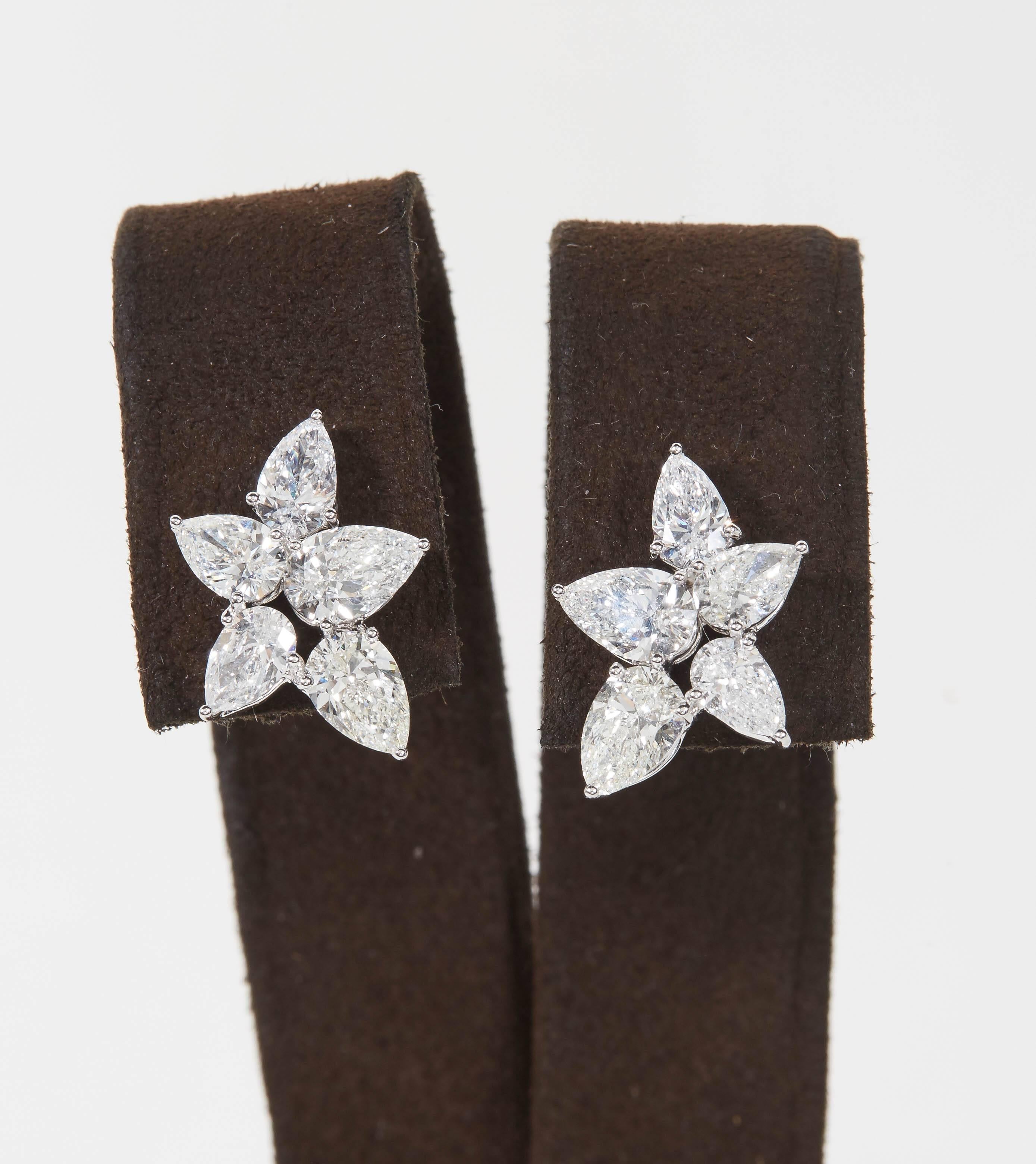 
An elegant and rich pair of diamond cluster earrings featuring larger sized diamonds. 

4.30 carats of white pear shaped diamonds. 

18k white gold 

Approximately .70 inches from the highest to lowest point. 

