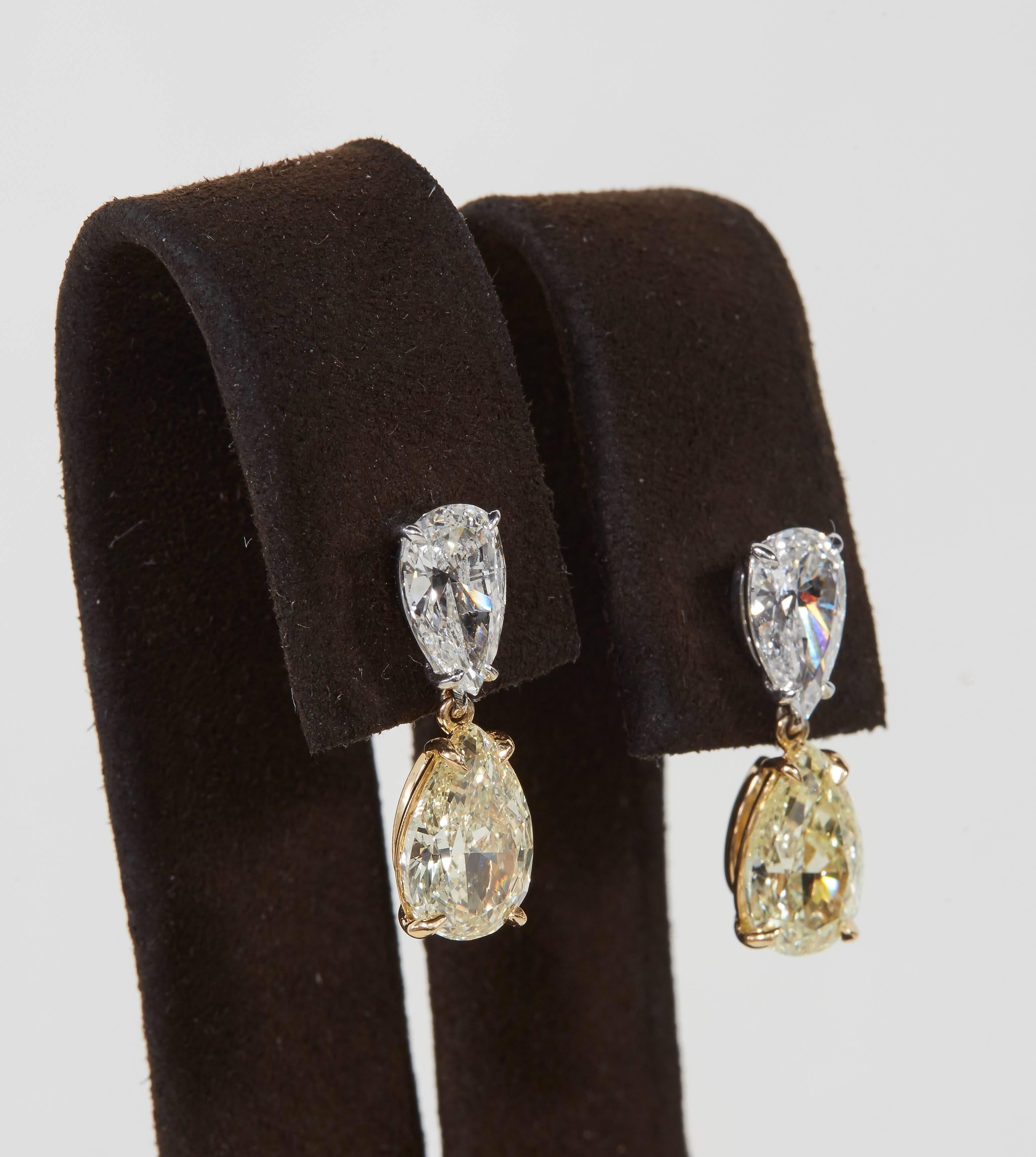 

An elegant pair of yellow diamond earrings.

A total of 1.82 carats of white pear shape diamonds 

A total of 4.01 carats of GIA certified Fancy Light Yellow VVS2 and VS2 diamond drops. 

All handmade in New York and set in 18k white and yellow