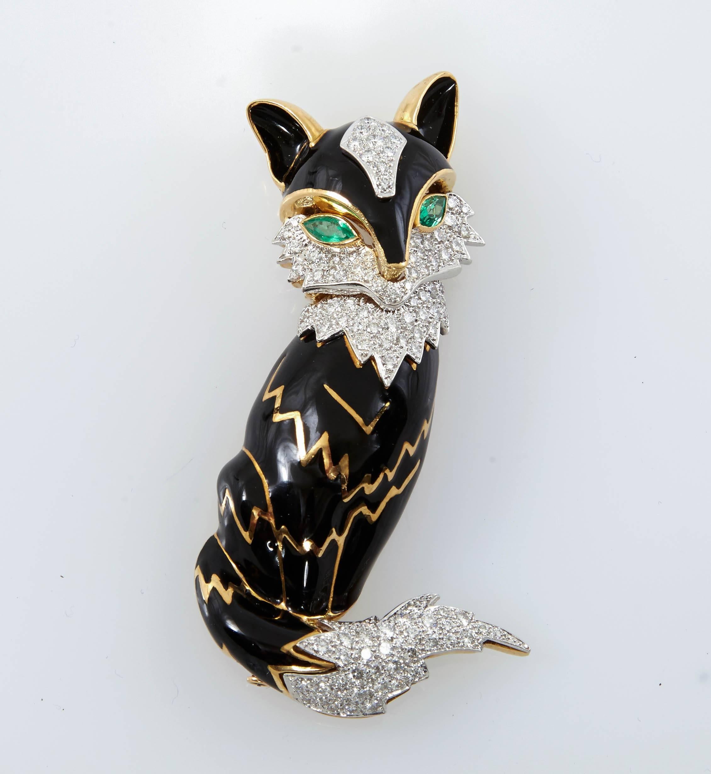 Stunning brooch designed as a black enamel fox, with marquise-cut emerald eyes and circular-cut diamond trim, all finely crafted in platinum and 18k gold. 