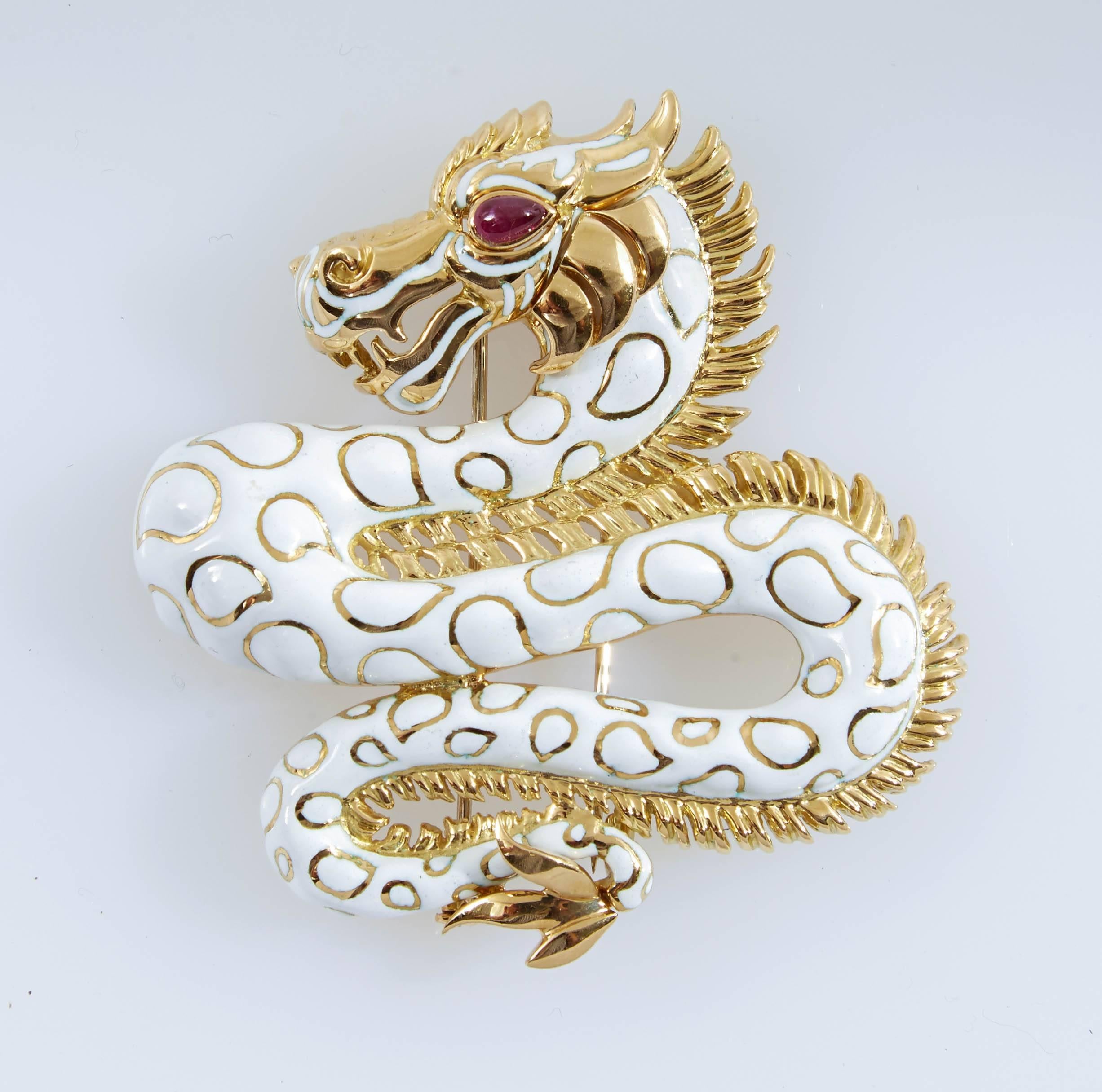 White enamel dragon brooch finely crafted in 18 k yellow gold accented with round brilliant cut Diamonds and cabochon Ruby. Signed David Webb