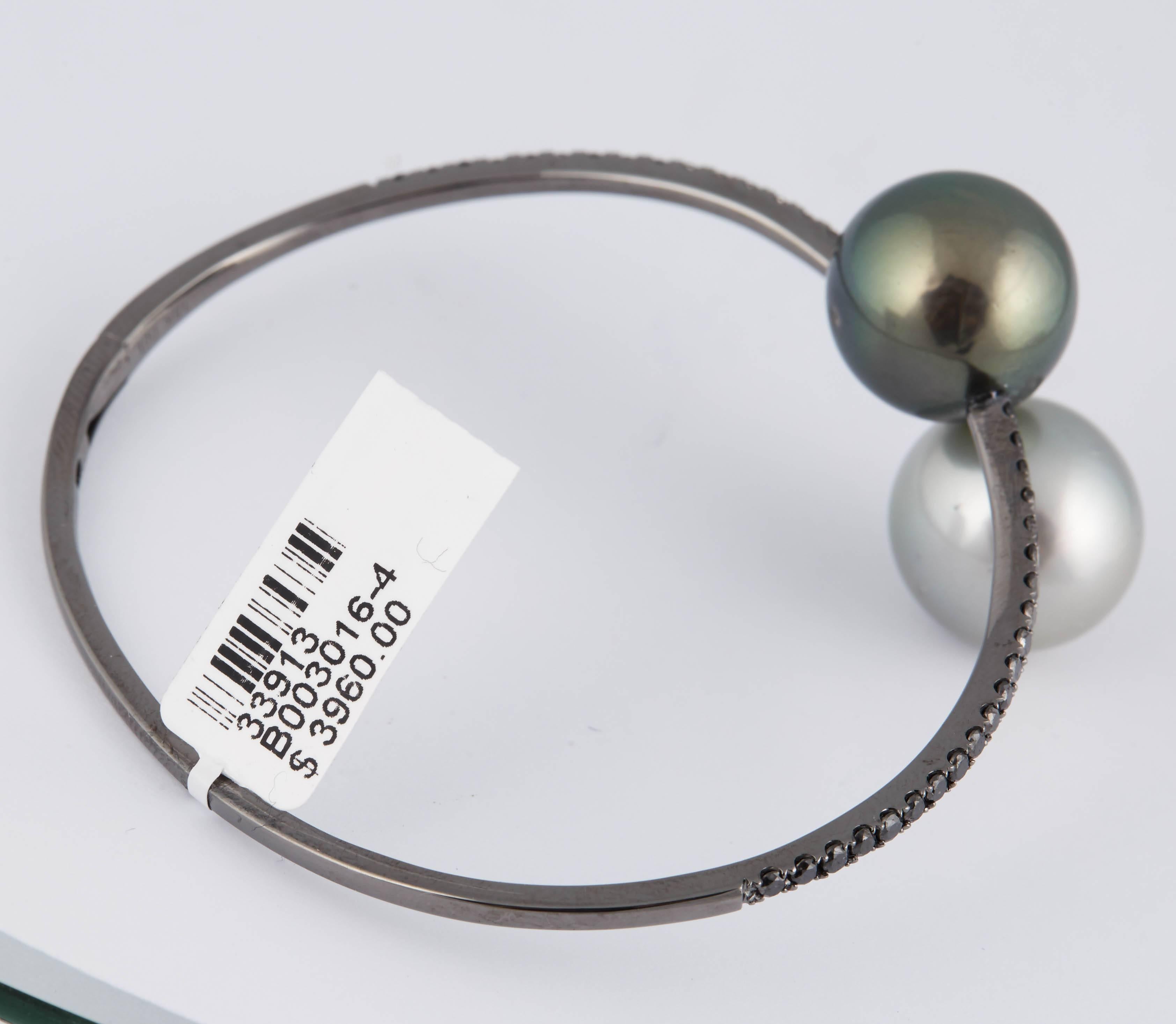 18K Black Rhodium bypass bangle bracelet featuring two Tahitian pearls measuring 13-14 mm with black Diamonds weighing 1.00 carat. 

Pearl Quality:	AA
Luster: AAA, Excellent
Nacre: Very Thick
