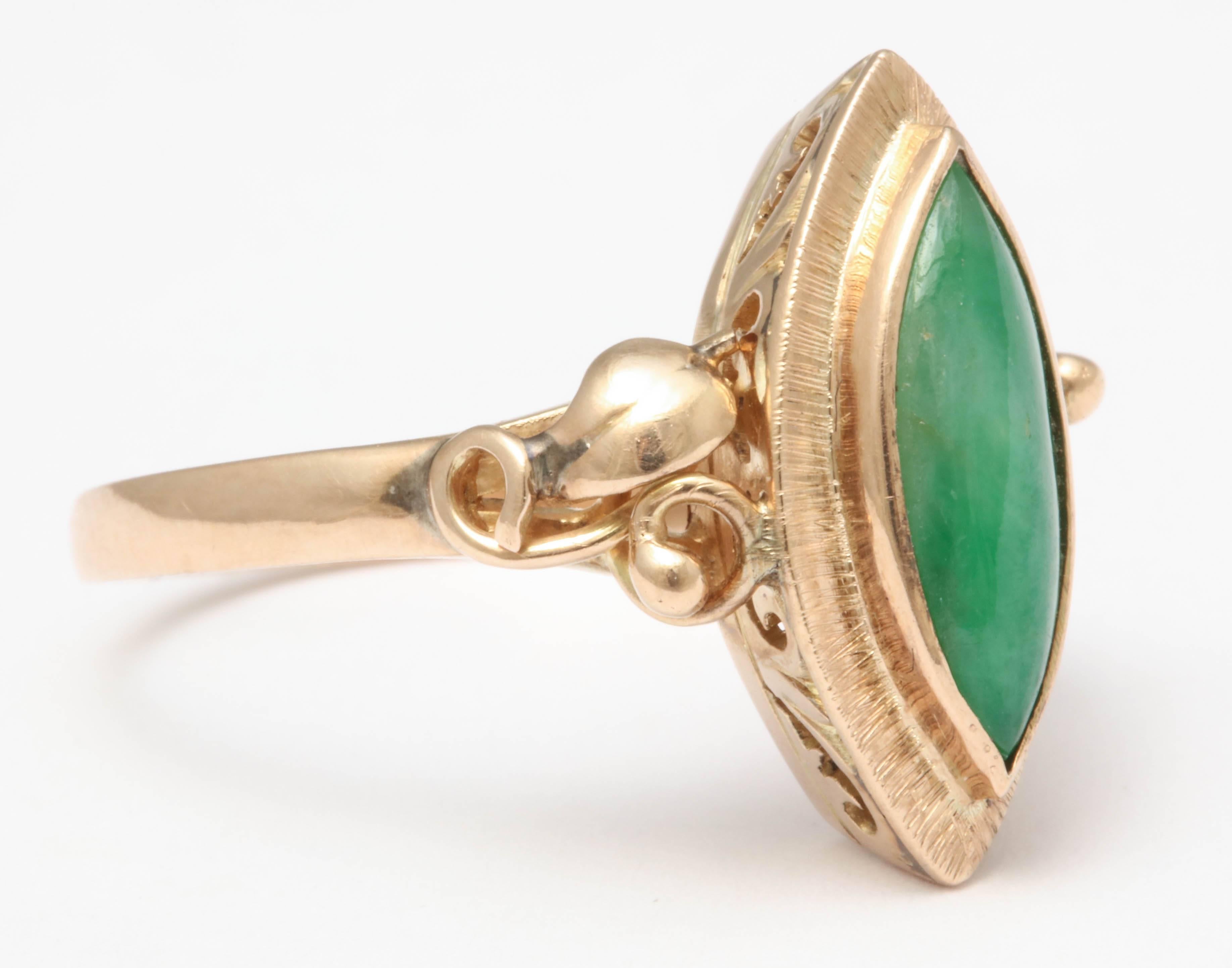 Art Nouveau Jade ring set in 9K. Navette shaped, with stylized leaf designs on the shoulders. 