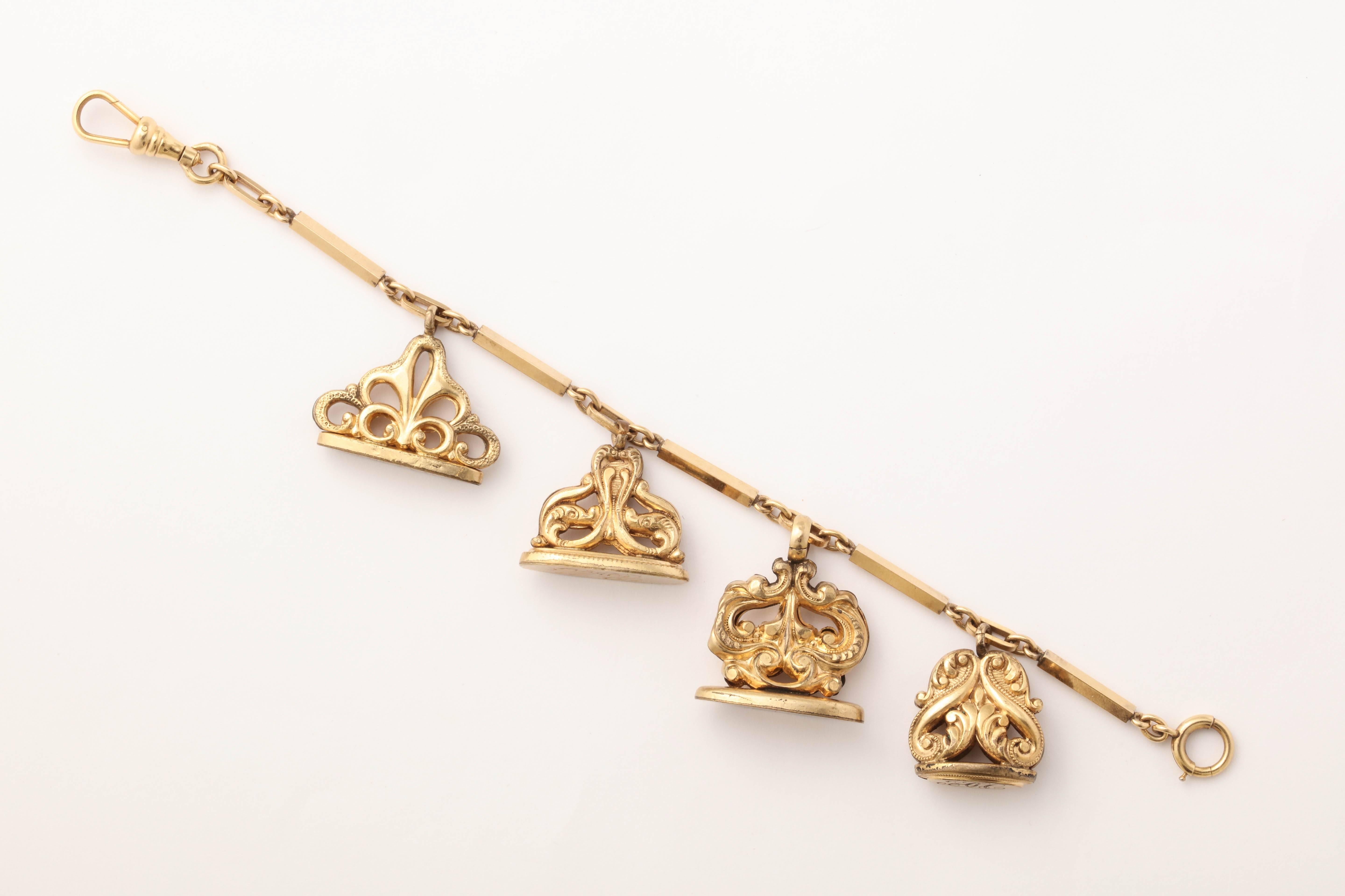 A fun, easy to wear charm bracelet made up of 4 Victorian Gold-filled watch fobs and watch chain. 