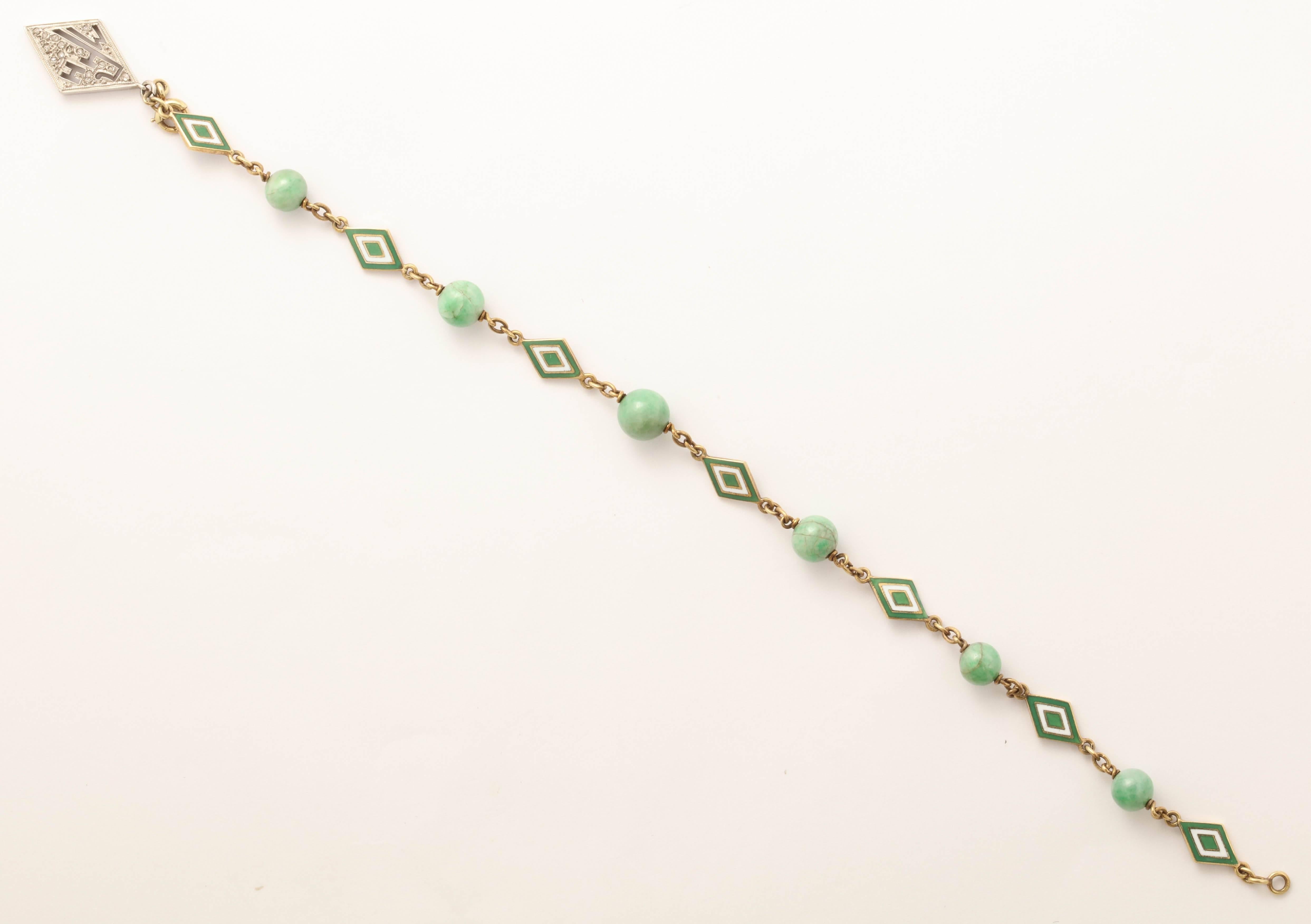 Apple jade beads alternate with lozenge shaped green and white enamel plaques. MHF initials on diamond charm- charm can be removed. 18K and platinum. 