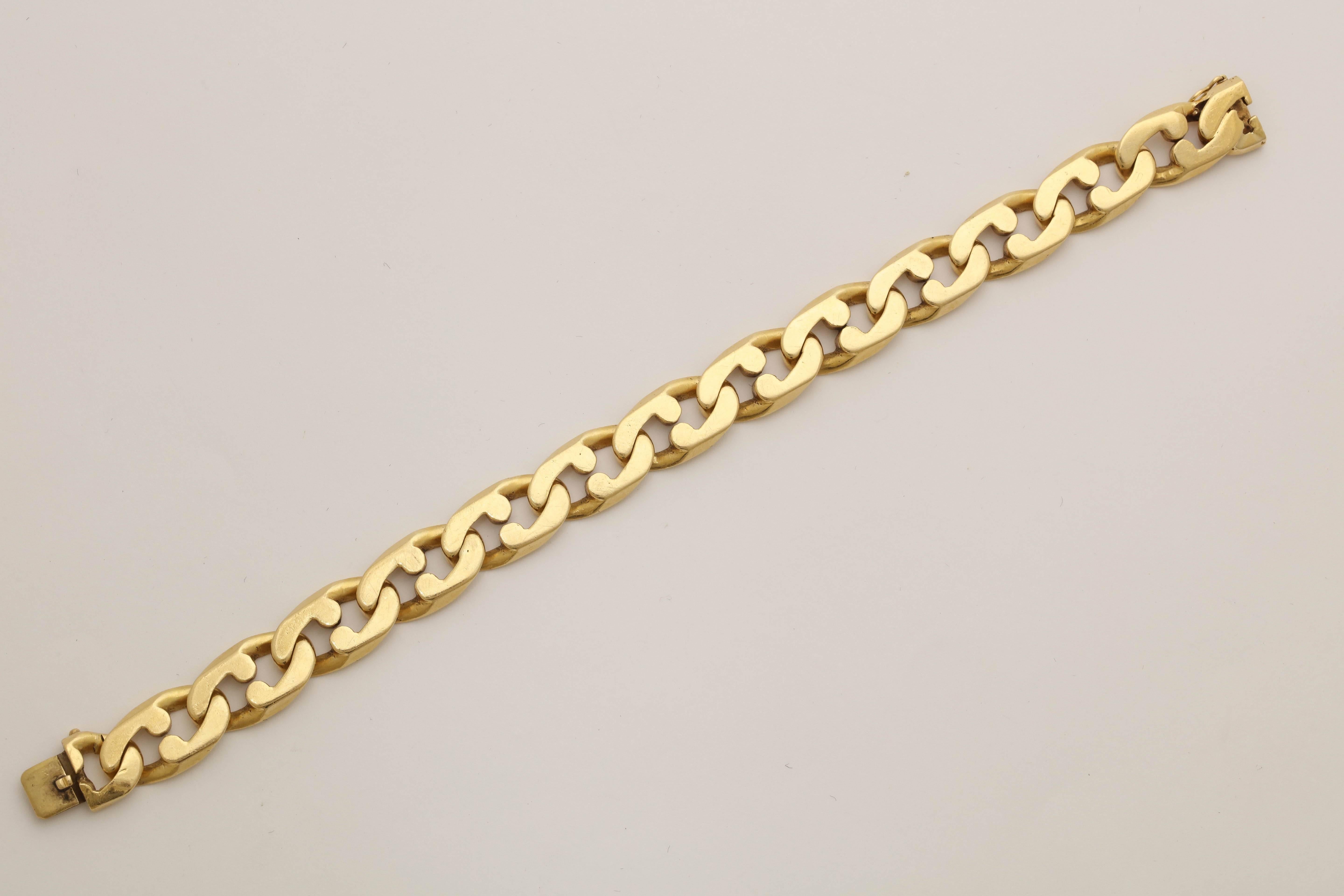 One Unisex Bracelet Designed In 18kt Yellow Gold In a Interlocking Jagged Curb Link Motif. Flexible Bracelet Is Made By Tiffany & Co. In The 1980's In America. Designed With a Figure Eight Safety Mechanism For Extra Security. 