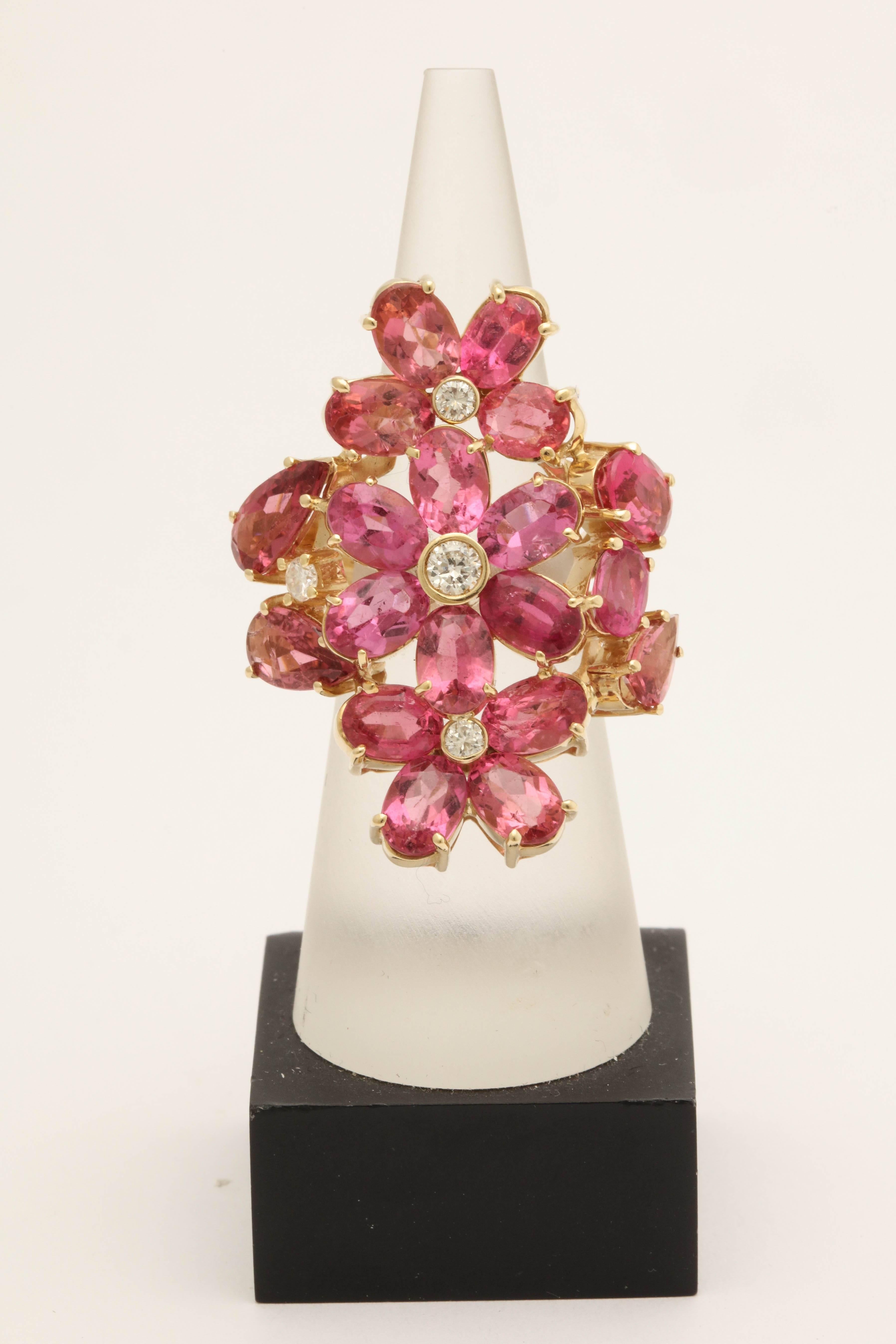 One Large Ladies Impressive Cocktail Ring Set In An 18kt Yellow Gold Setting And Embellished With Numerous Faceted Intense Natural Color Pink Tourmalines Weighing Approximately 5 Carats Total Weight. Cocktail Ring is Further Designed With Four Bezel