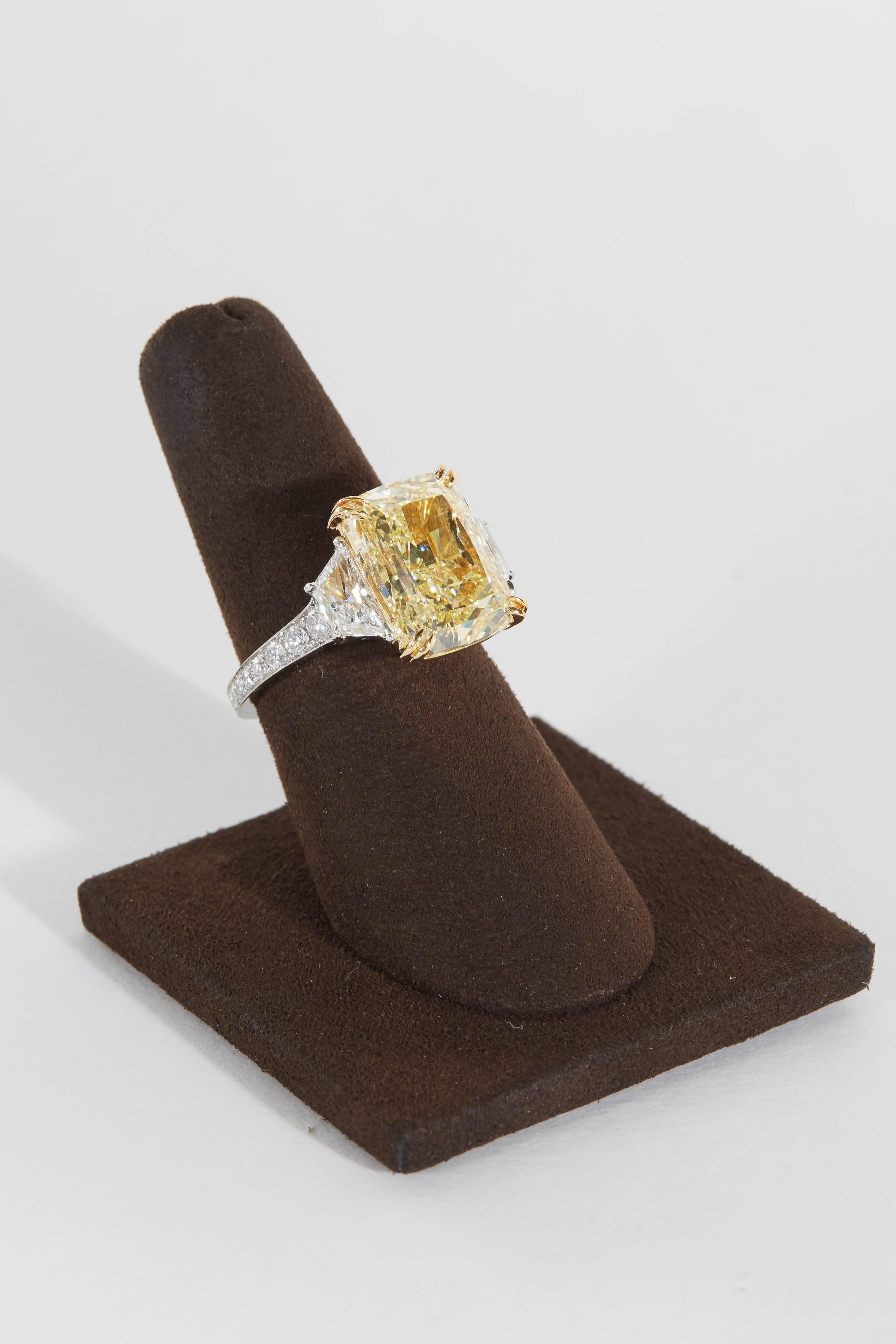 

An amazing diamond full of sparkle and brilliance! A rare and most sought after rectangular shape!

GIA certified Fancy Yellow 10.17 carat SI2 center diamond.

1.55 carats of white diamonds set along the side of the center and along the band.