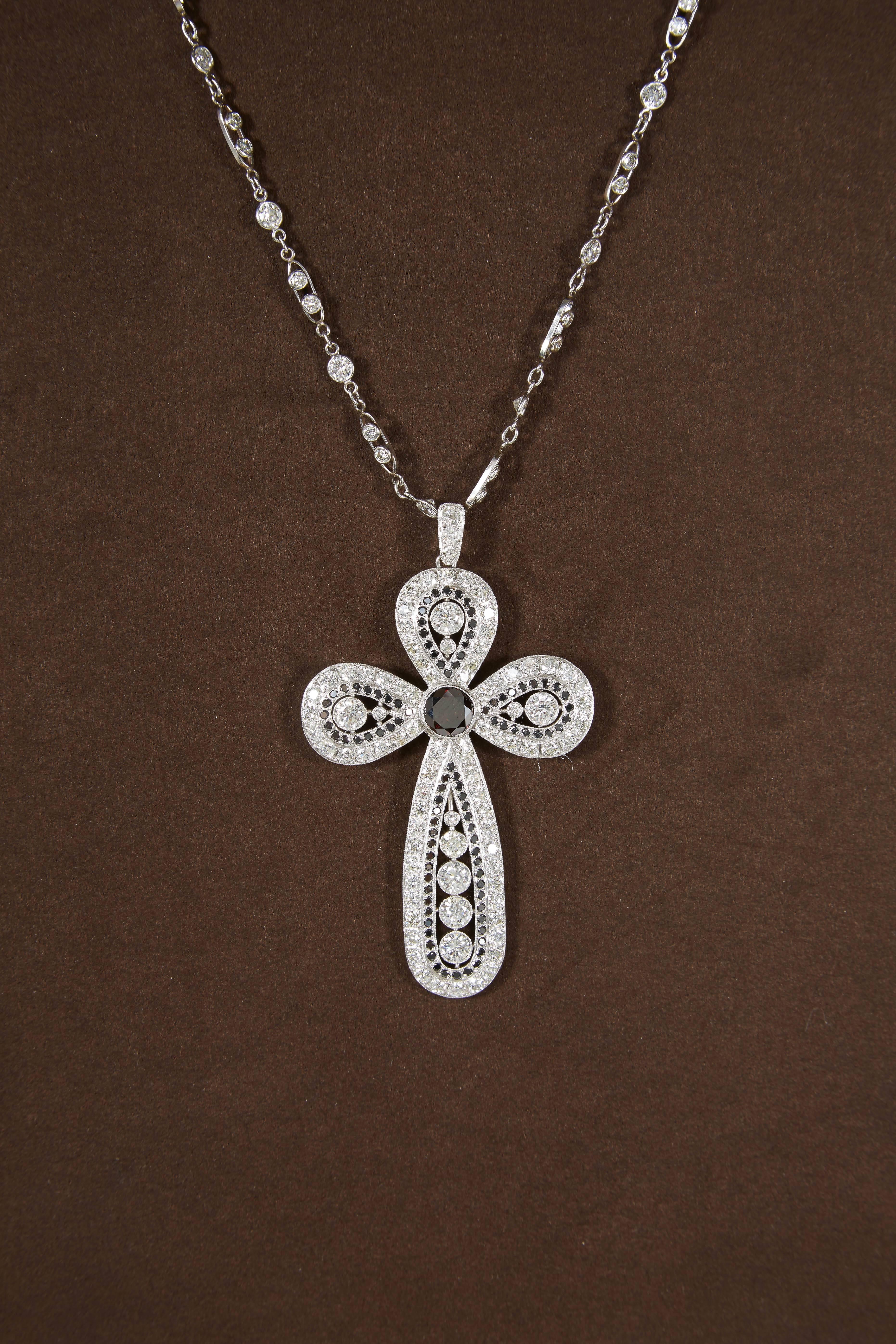 

Beautiful diamond cross with black diamond accents. 

This unique piece is hand crafted in platinum and has a vintage feel. 

5.80 carats of diamonds plus 1.20 carat reddish black diamond center. 

The diamond chain is platinum and has 6.11 carat