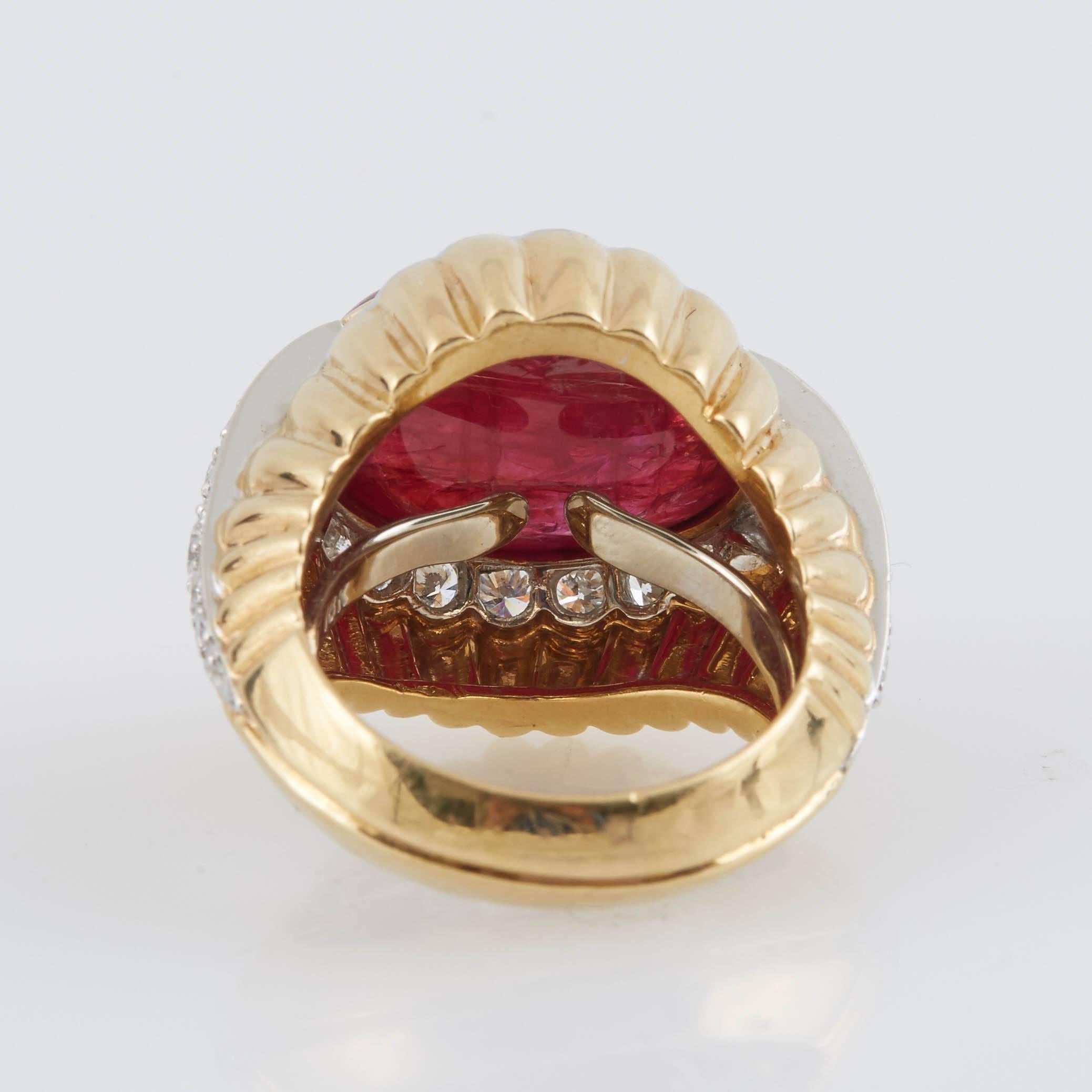 David Webb earrings and ring set, finely crafted in 18k yellow gold with an oval shaped cabochon ruby weighing approximately a total of 22.00 carats and diamonds weighing approximately a total of 7.00 carats.