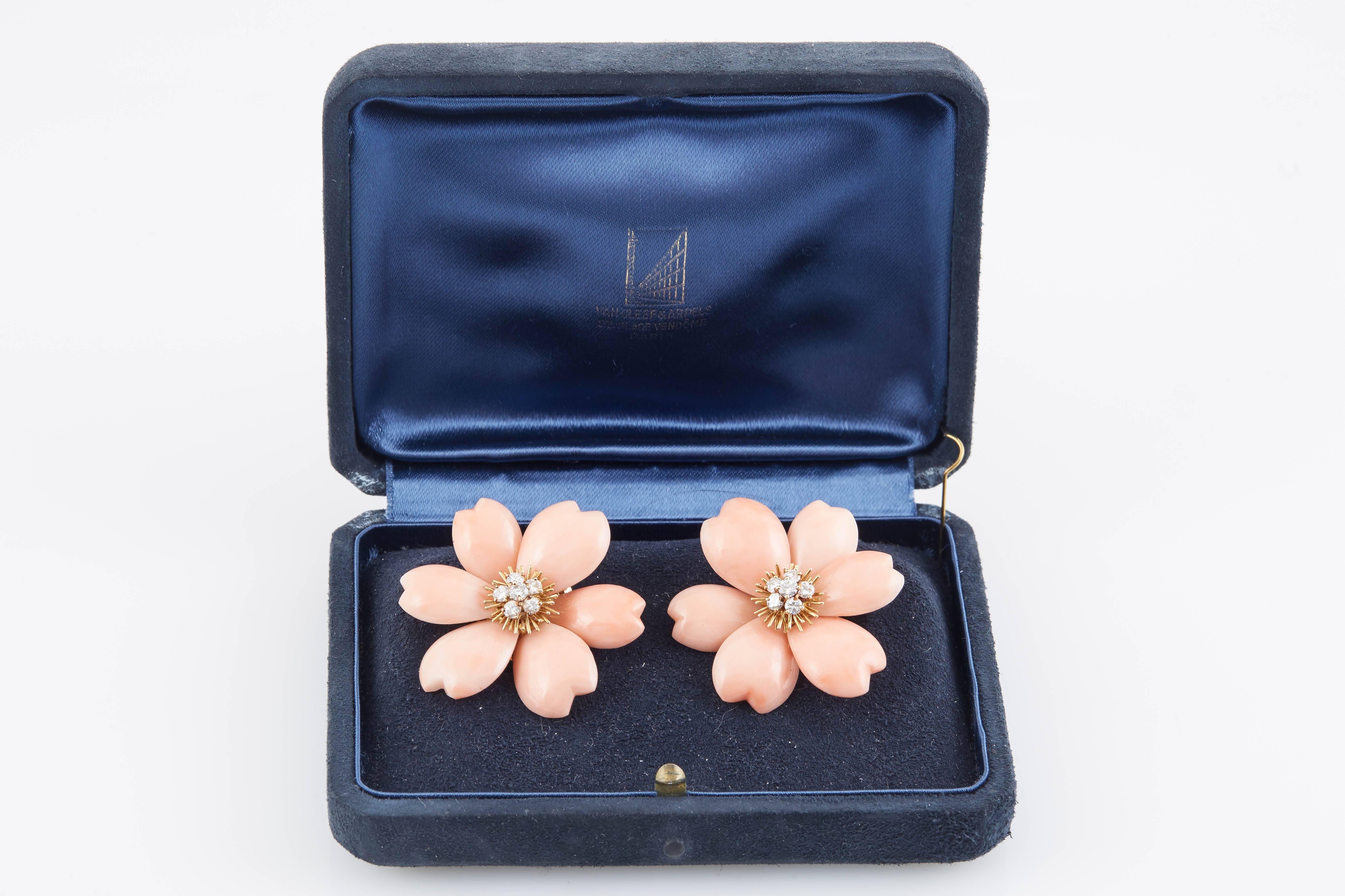 Beautiful coral  Earrings by Van Cleef & Arpels. Each of floral design composed of coral petals around clusters of brilliant-cut diamonds. Total diamond weight 1.00 carat.The earrings have post fittings French assay and maker's marks, Van Cleef &