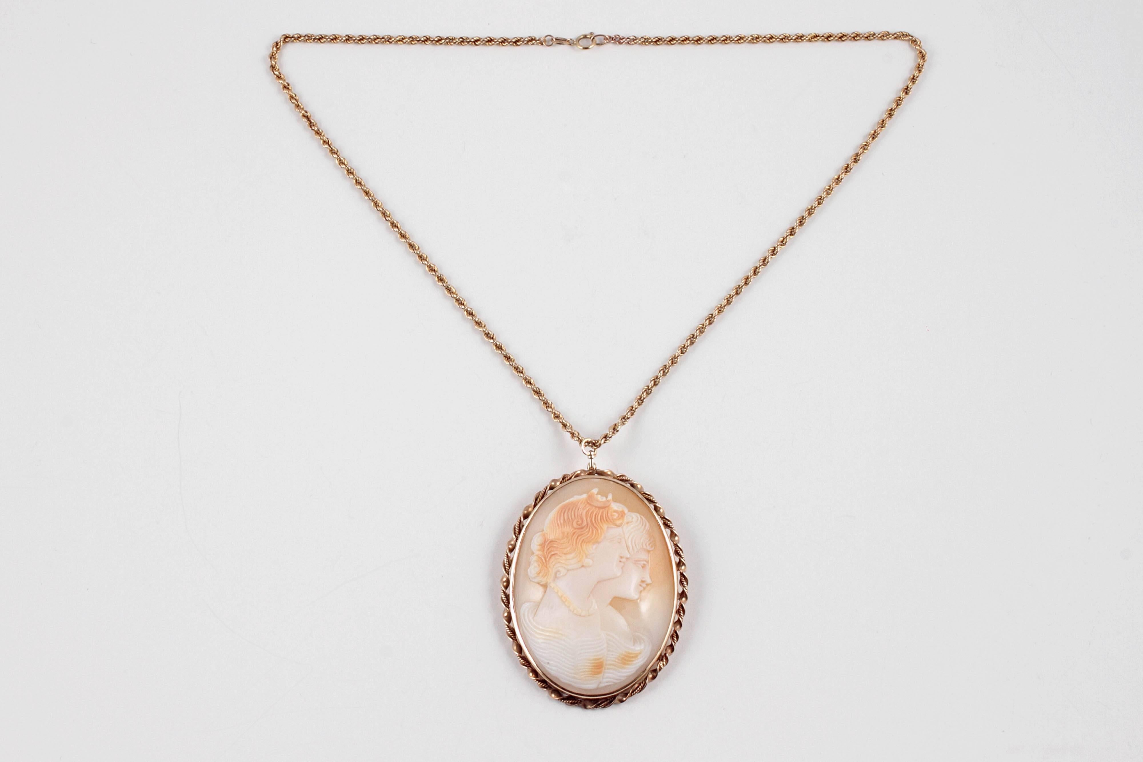 Lovely and unusual -  14 karat yellow gold cameo depicting two female forms, one with a lovely strand of pearls encircling her neck!  The cameo measures 2 3/4 inches length x 2 inches in width and is suspended from an 18 inch 9 karat yellow gold