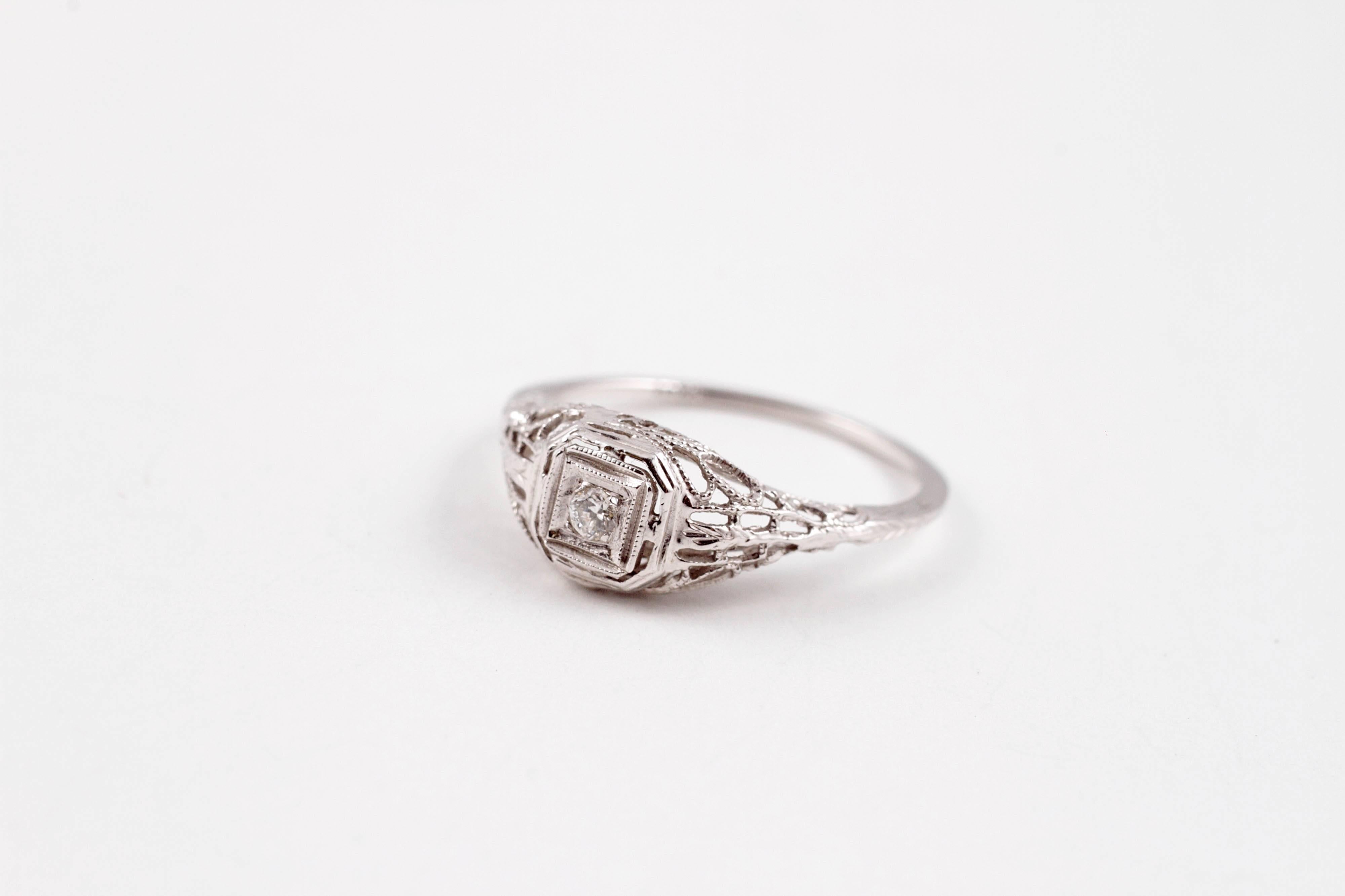 Beautiful Art Deco white gold diamond ring!  Centered with a 0.05 ct diamond, in a size 5 3/4. 
