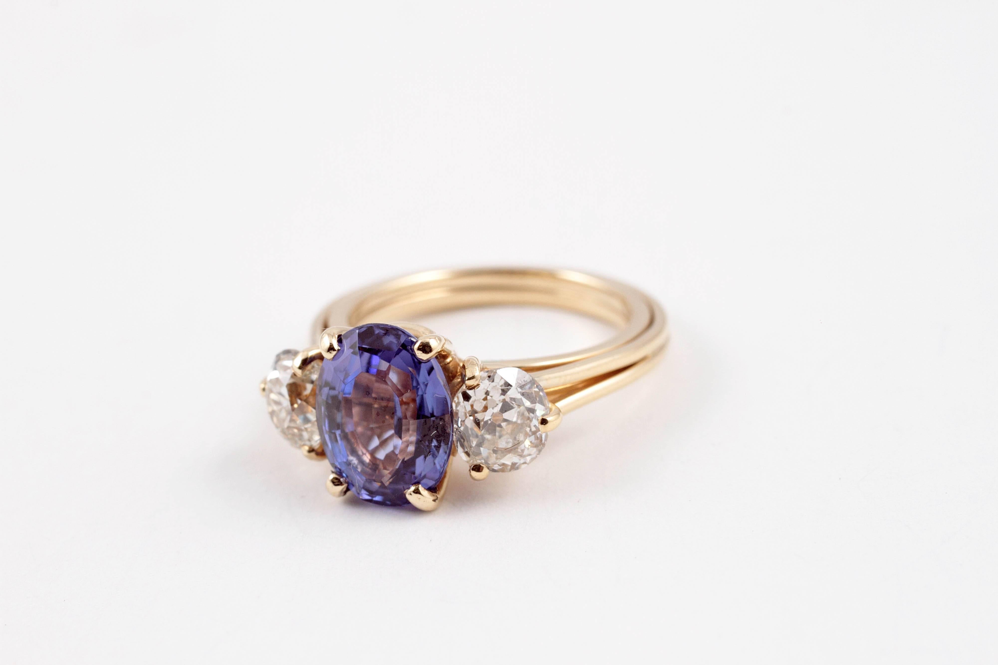 Breathtaking 2.96 ct Tanzanite and 1.50 carat old European-cut diamonds!  In 18 karat yellow gold contemporary mounting, it is just fabulous to see and behold!  Size 5.50, sure to make anyone happy to find this under the tree!