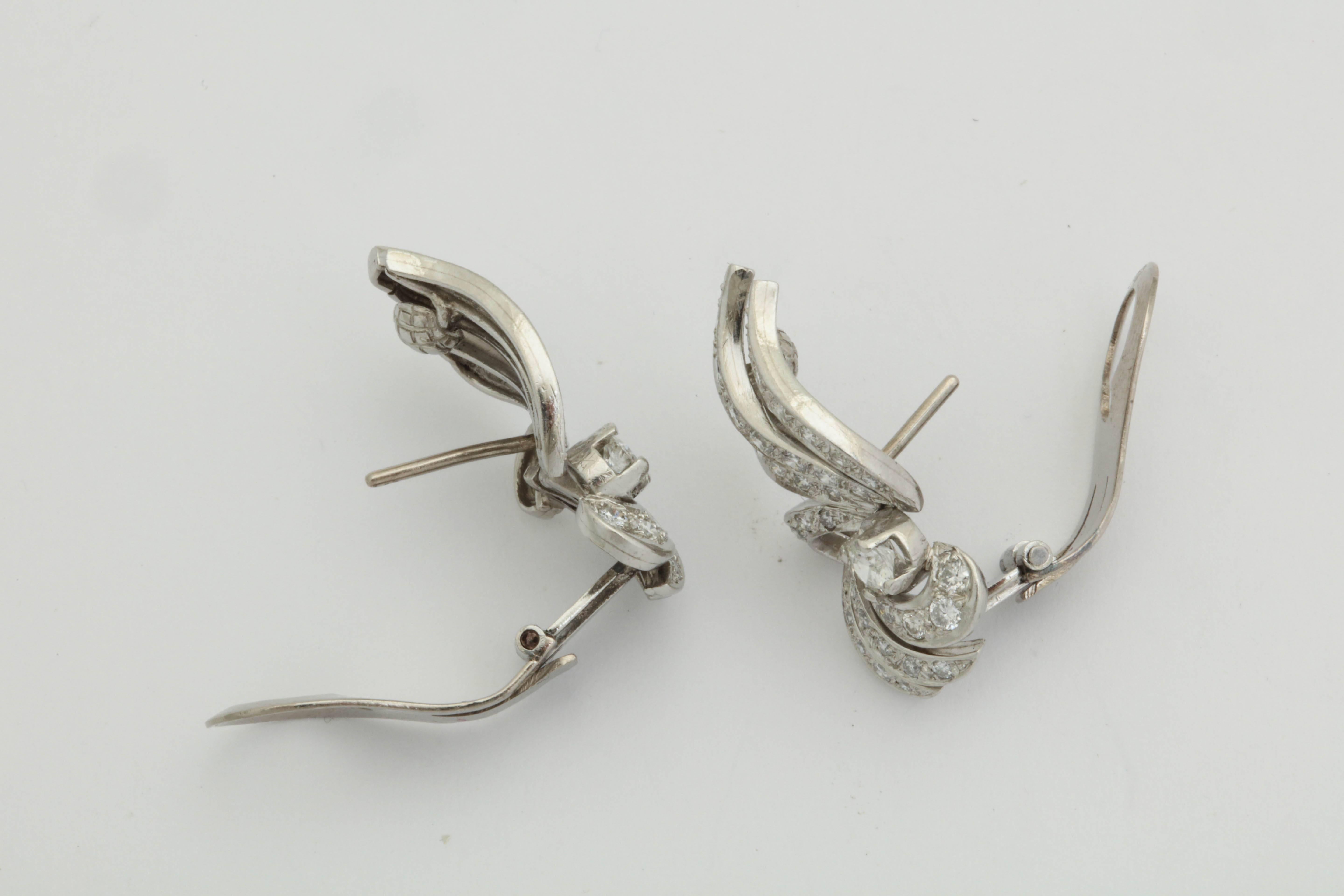 Round Cut 1950s Flame and Wing Design Diamond Encrusted Platinum Earclips with Posts