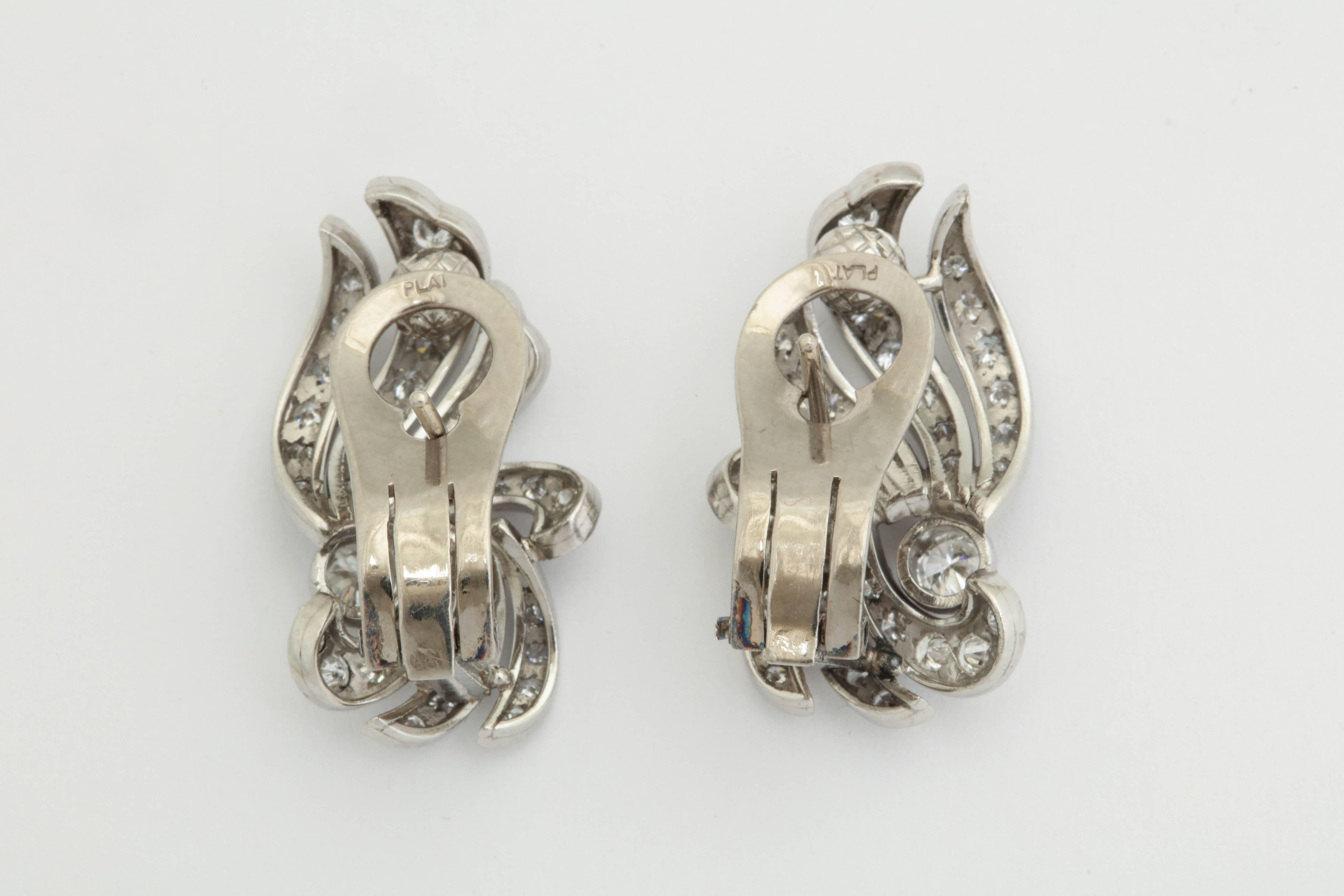 1950s Flame and Wing Design Diamond Encrusted Platinum Earclips with Posts In Good Condition In New York, NY