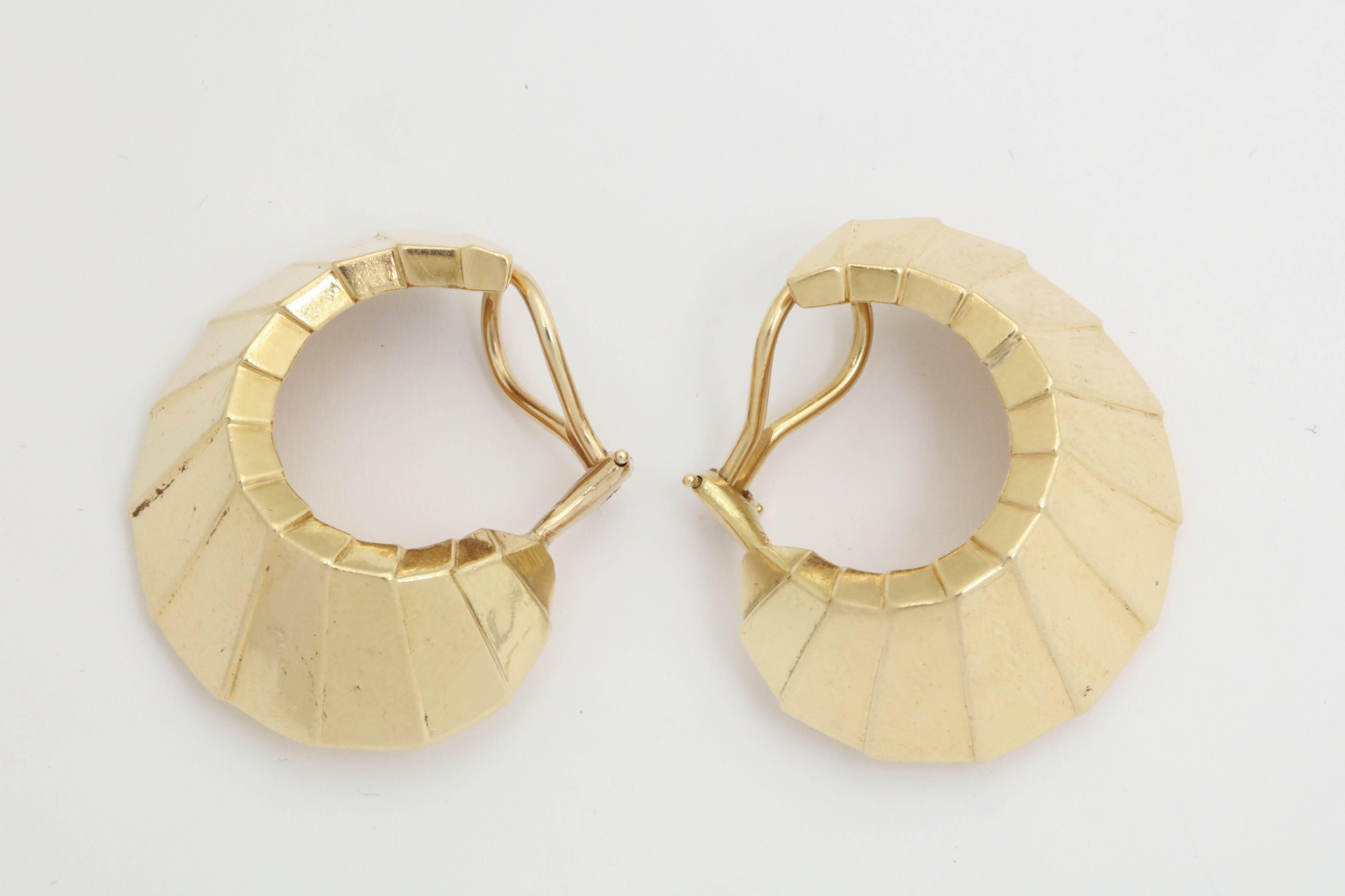 One Pair Of Ladies 18kt Yellow Gold Flared Out Fan shaped Design Earrins Consisting Of thirty Gold Panels For A Optical Illusion Effect Of Mirrors Being Worn.Omega Backs Made In 14kt Yellow Gold For Extra sturdiness,. NOTE: Earrings May Be Worn