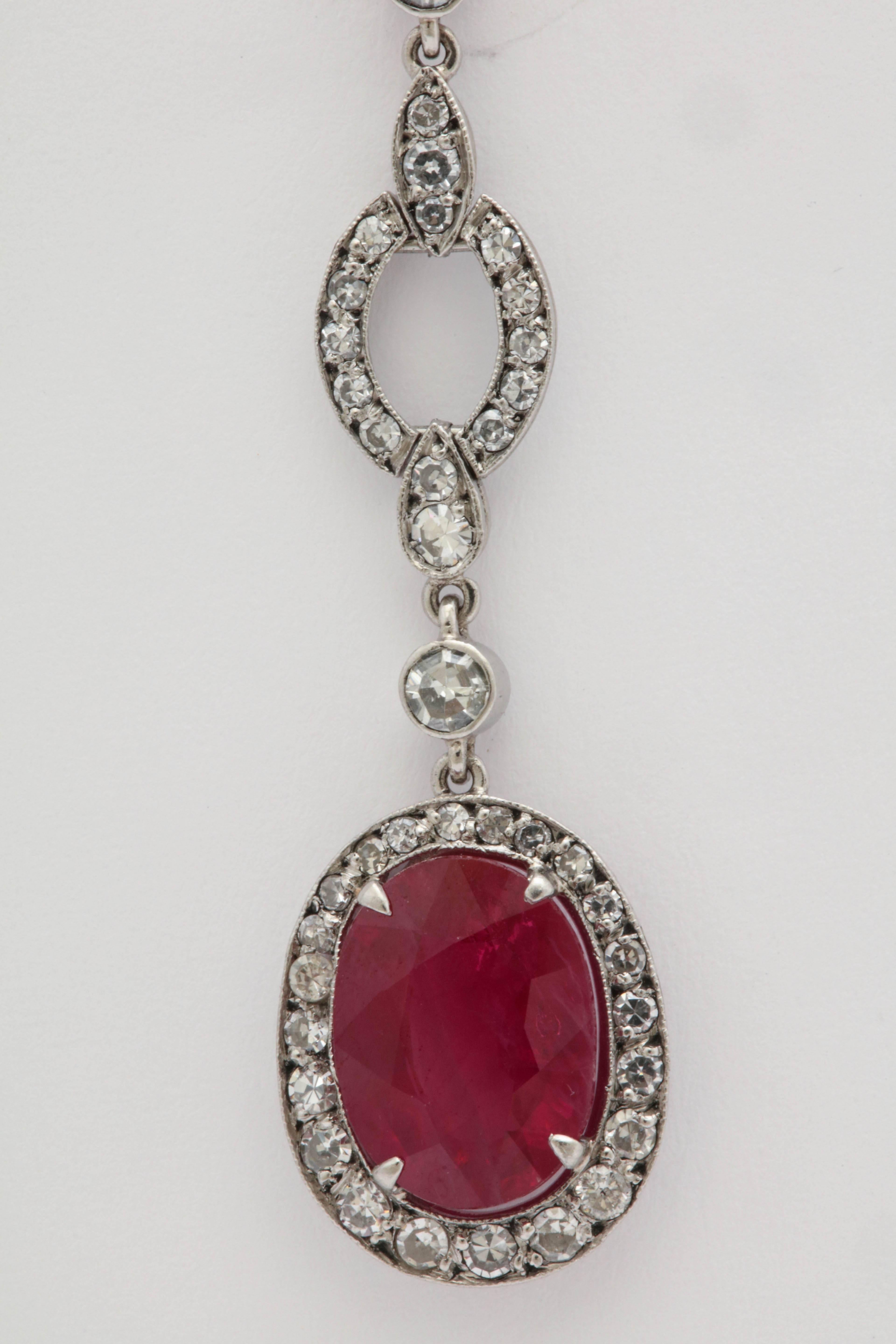 One Pair Of Ladies Platinum And Diamond Drop Pendant Earrings Designed With Two Faceted Scissor Cut Rubies Weighing approximately Two Carats Each, Beautiful Color And Cut.Total Approximate Weight Of diamonds Approximately Two Carats. Beautifully