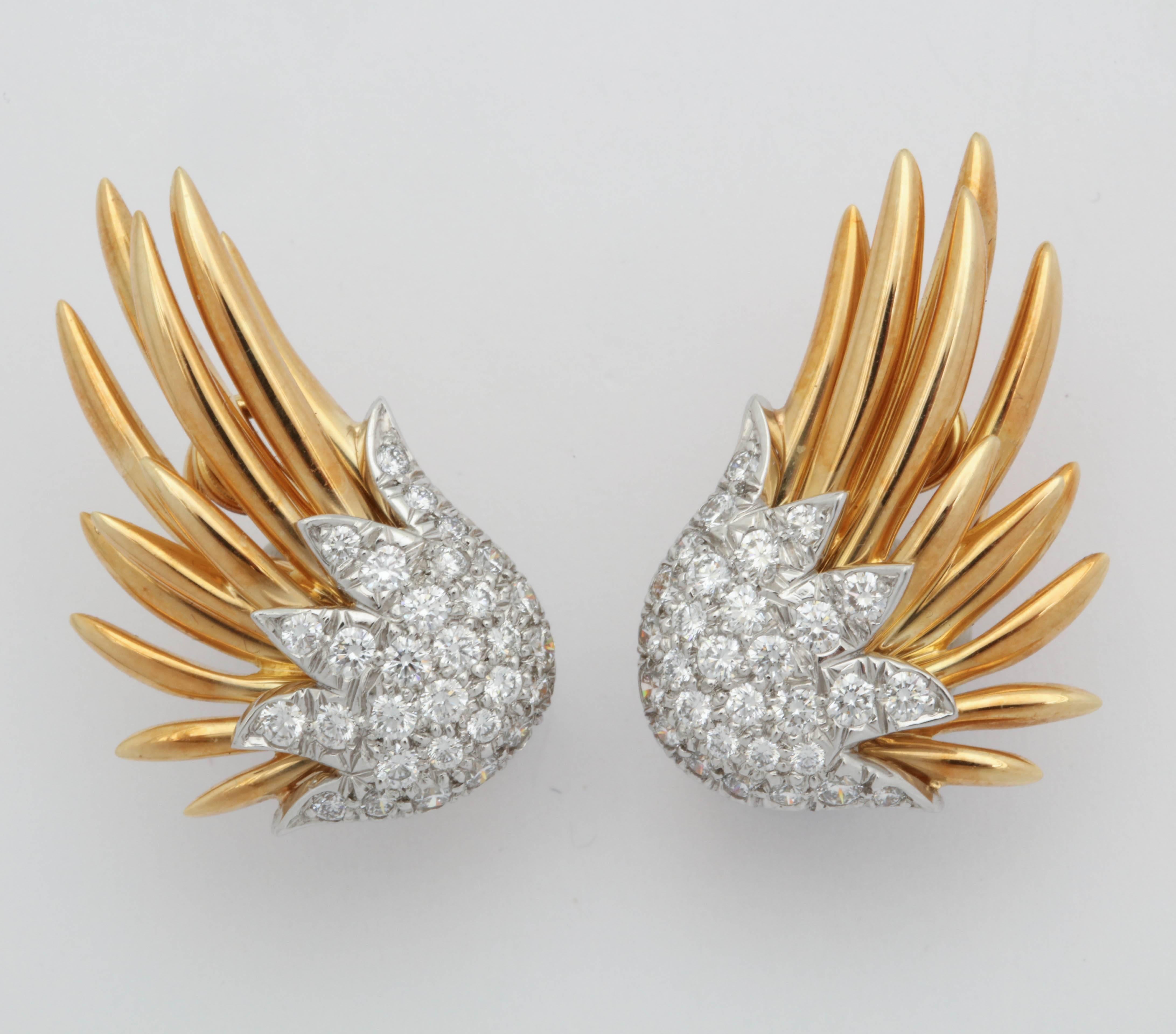 One Pair Of Ladies Flame Design Earclips With Posts Embellished With Approximately 2 Carats Of G-H Quality VVS2 Quality Full Cut Diamonds. Diamonds Are Set In Platinum And Earrings Are Made Out Of Solid 18kt Yellow Gold. This Is A Well sought After