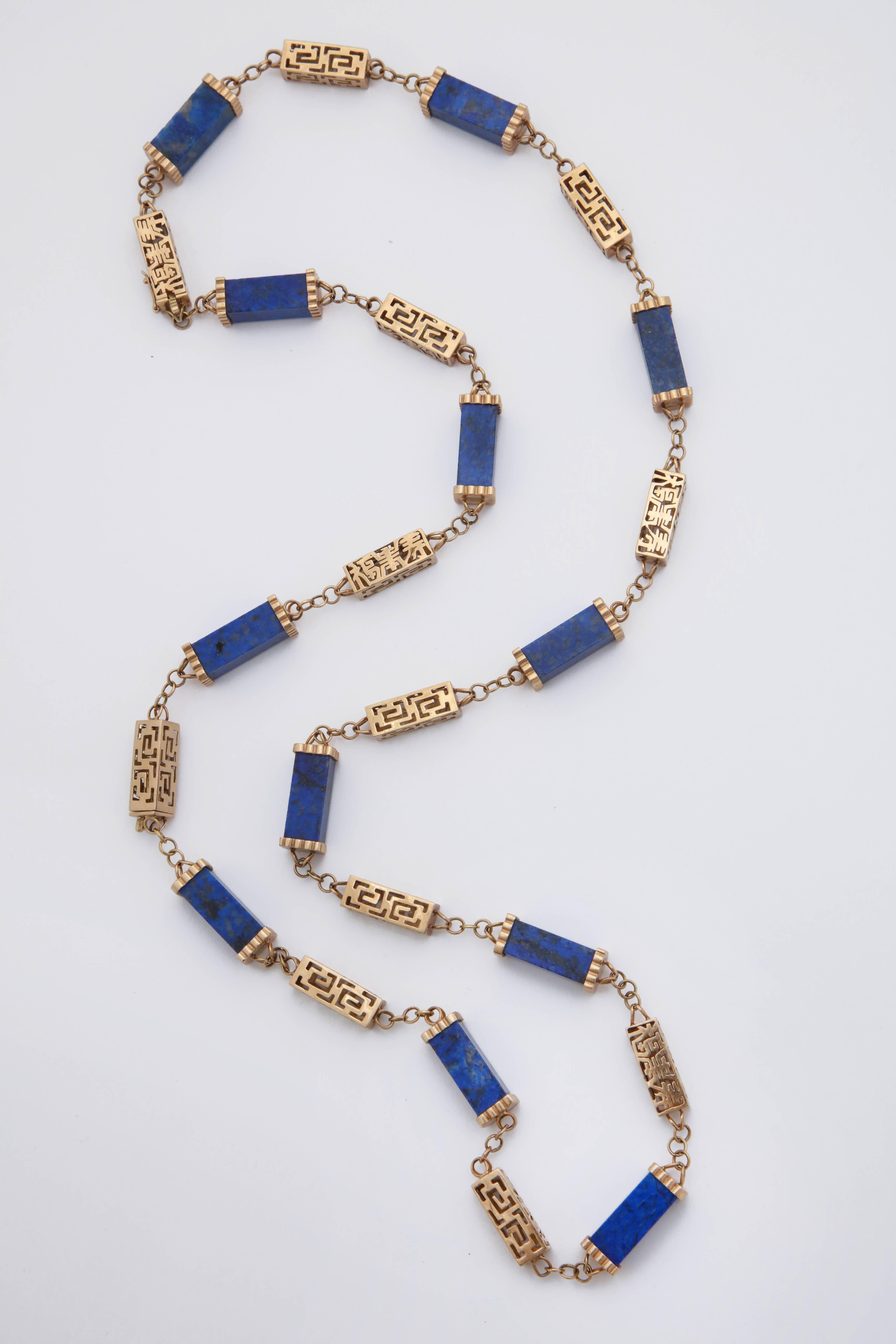 One 14kt Reticulated Gold Approximtely 31 Inch Chain with An Asian motif Style Design Composed Of 12 Three Dimensional Open Links And Further Designed with Alternating Three Dimensional Cynlinder Shaped Beautiful Color Lapis Lazuli Stones Measuring