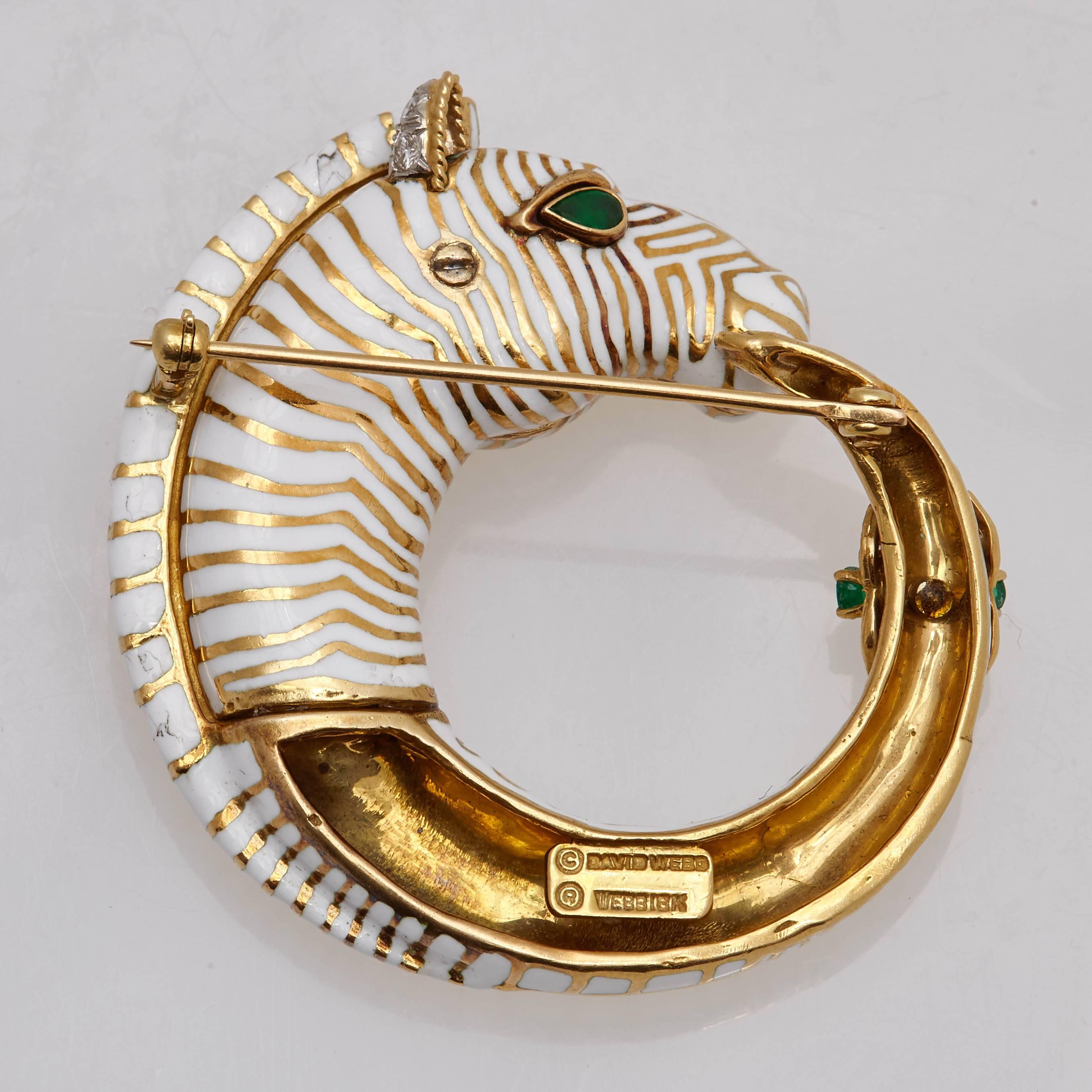 An 18K Gold, White & Black Enamel Zebra brooch with Emeralds, by David Webb. Made in the United States, circa 1970s. 