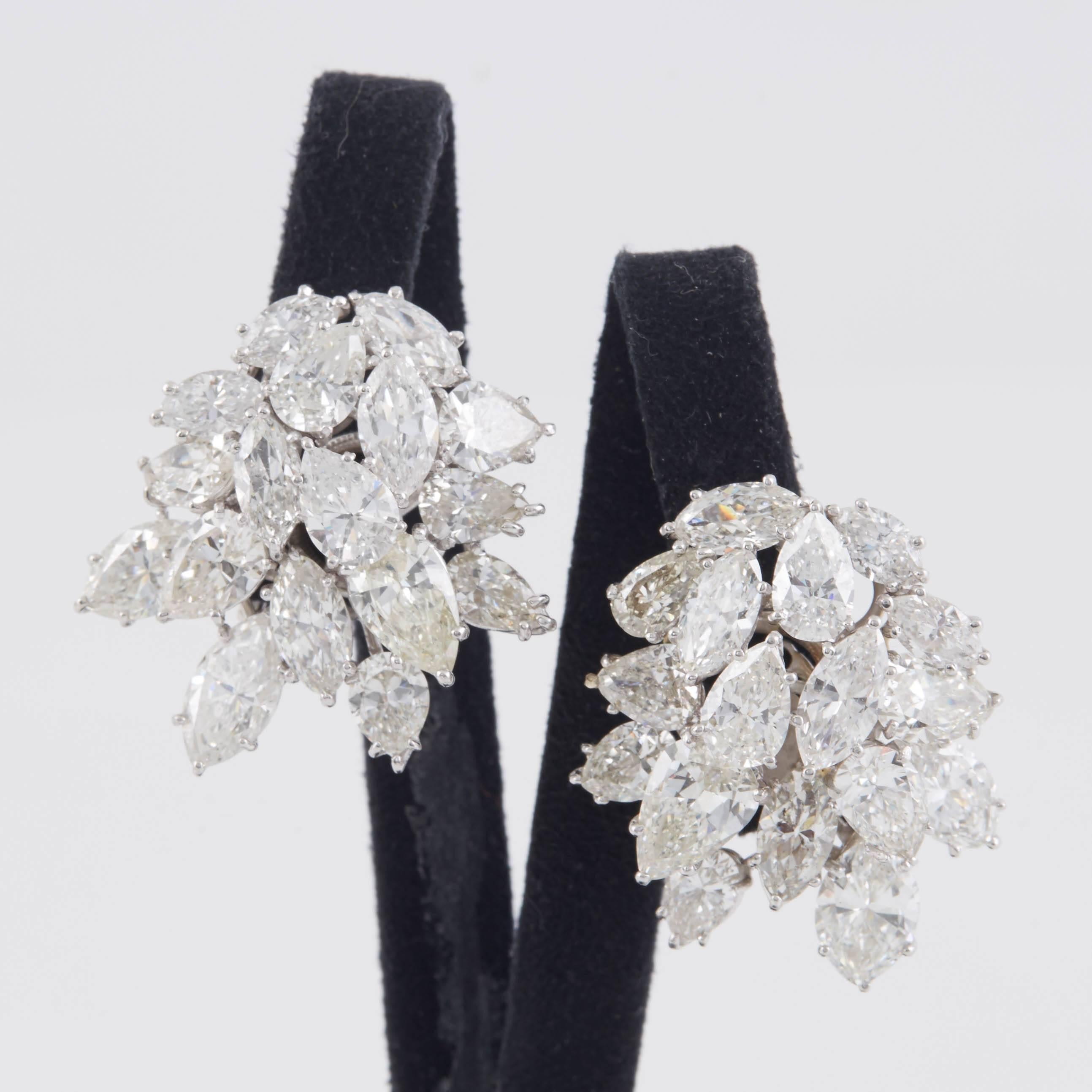 Stunning diamond cluster earrings, finely crafted in platinum with marquise and pear shape cut diamonds, weighing a total of approximately 32.00 carat. 