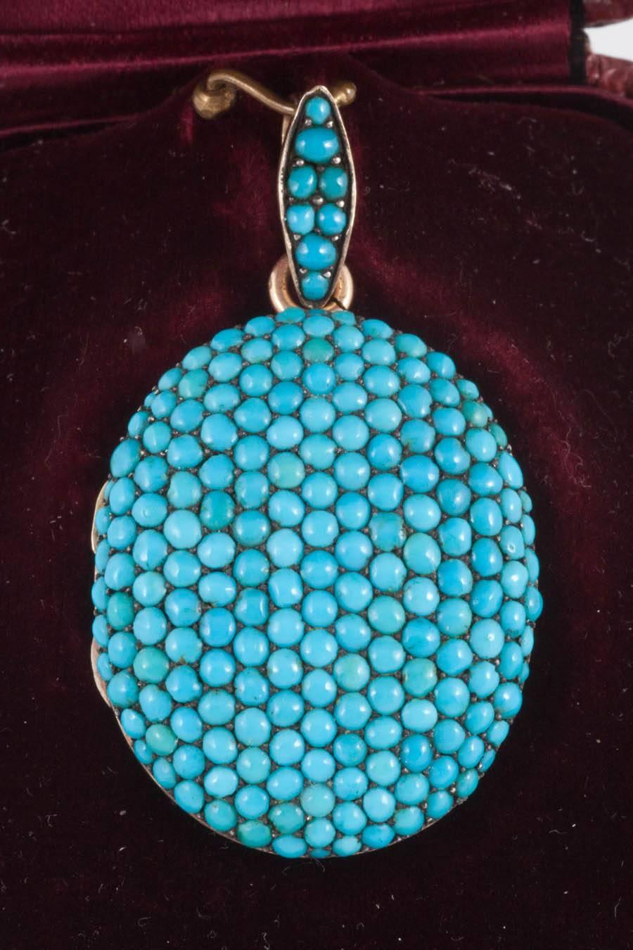This 18ct Gold locket is set with natural Persian Turquoise in Pave setting. Has an engraved gold back