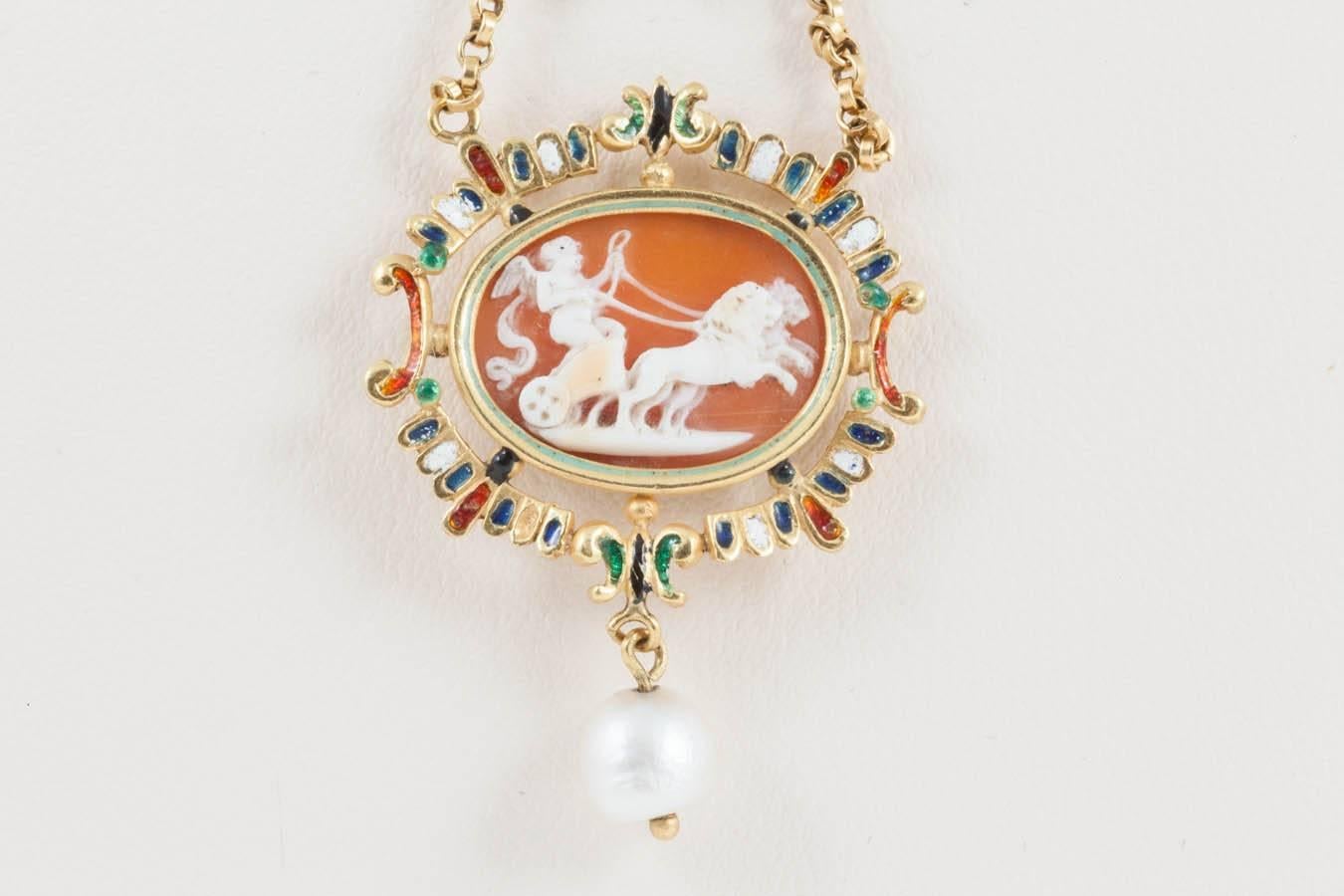 A 19th century copy of a Holbeinesque 16th century pendant. The eye on the reverse wards away evil. A charming hand carved cameo with the enamel surround and natural pearls are suspended. The central cabochon ruby is set to the bale. The style of