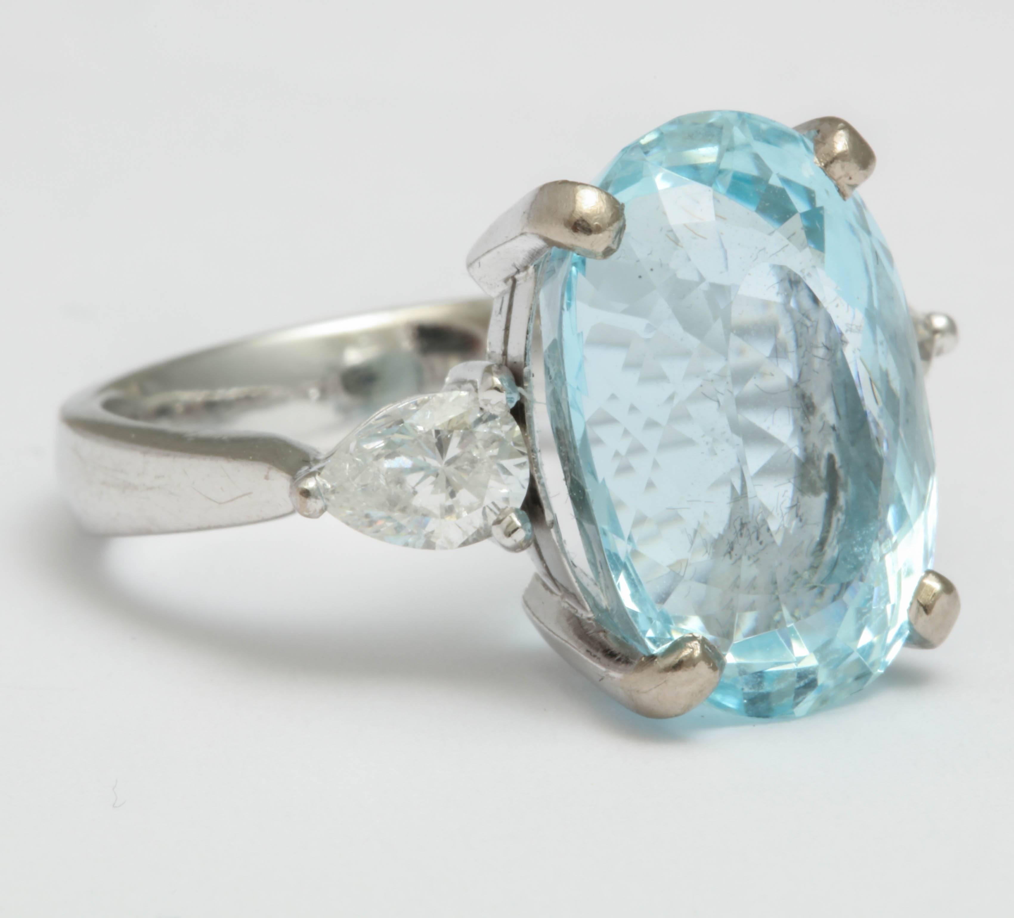 Aquamarine and Diamond Ring  Prong set in Platinum with Pear Shaped Baguettes.  Total weight of the Baguettes is 45pts.  Size of Aqua is 15carats.  Aqua is very well faceted with extra facets providing this stone with a great deal of brilliance and