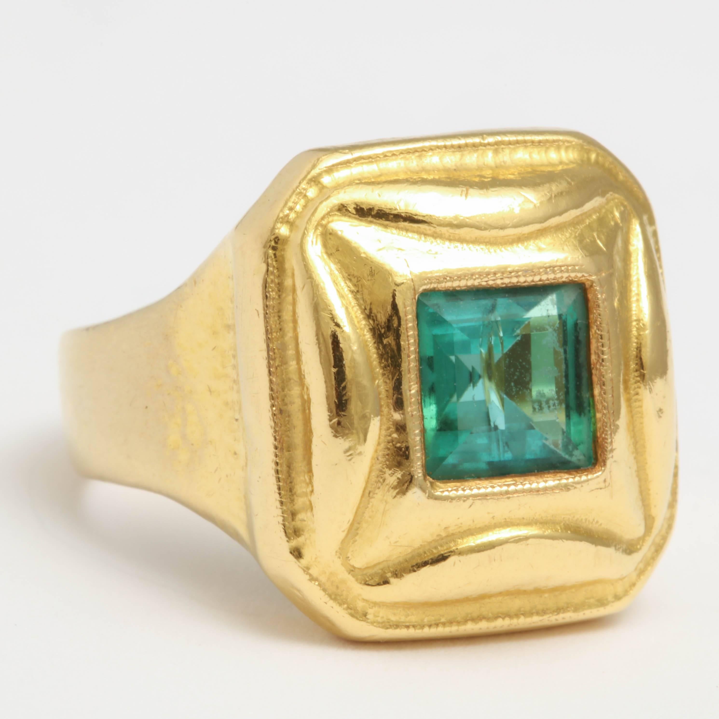 18kt Yellow Gold Ring Mounted with a square shaped Emerald in the Center.  Beautiful Clarity & color.  No certificate included.  It is now 6 1/4 but can be sized up or down. Signed with an un-identified Monogram and marked 750 indicating a European