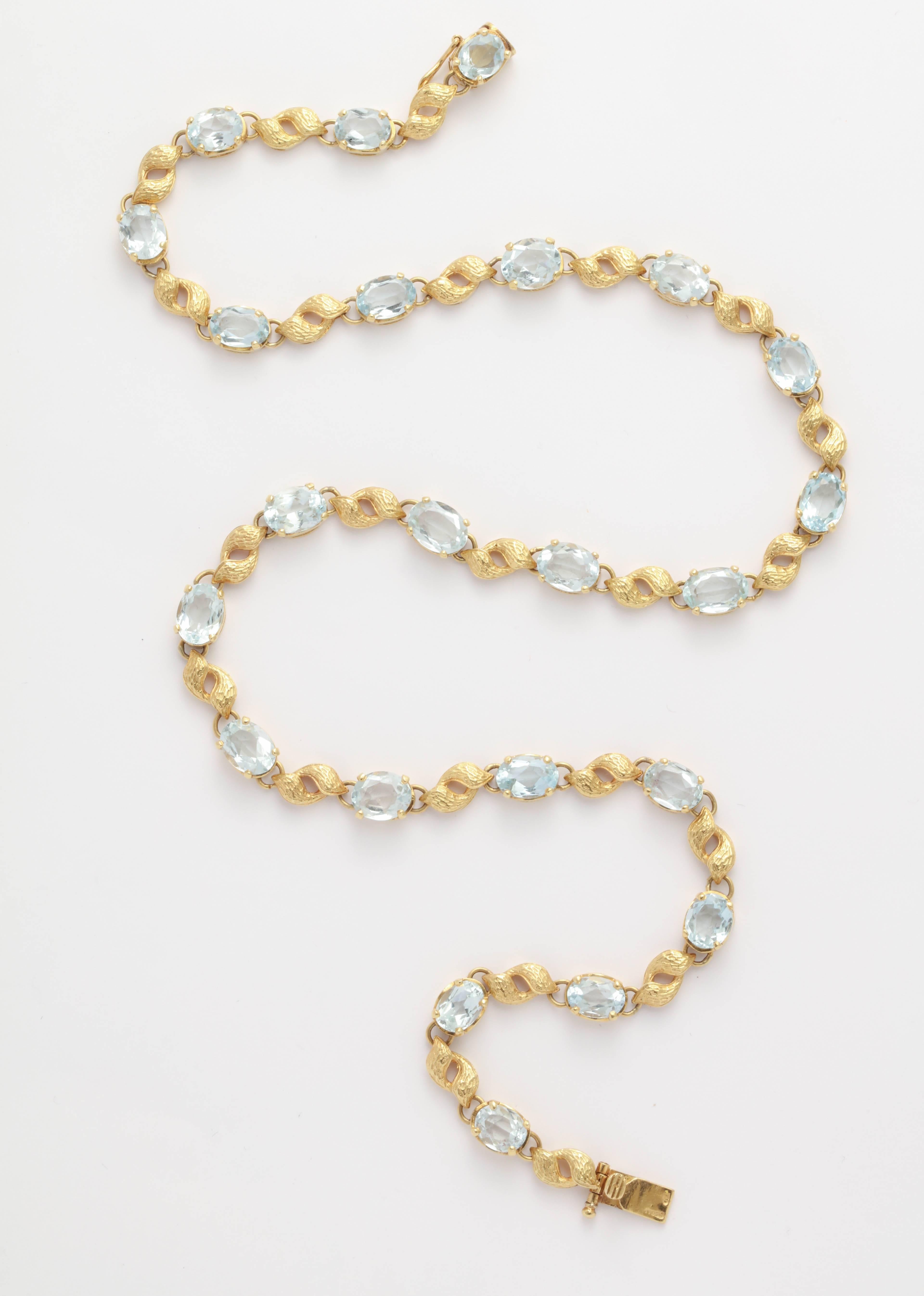 Very Graceful and delicate Necklace composed of an 18kt engraved Floral Leaf and alternating with a faceted Aquamarine.   Pale blue Aquas and Gold forming a circlet .  Marked 750.  Total weight of Stones - Approximately 25 Carats.
 