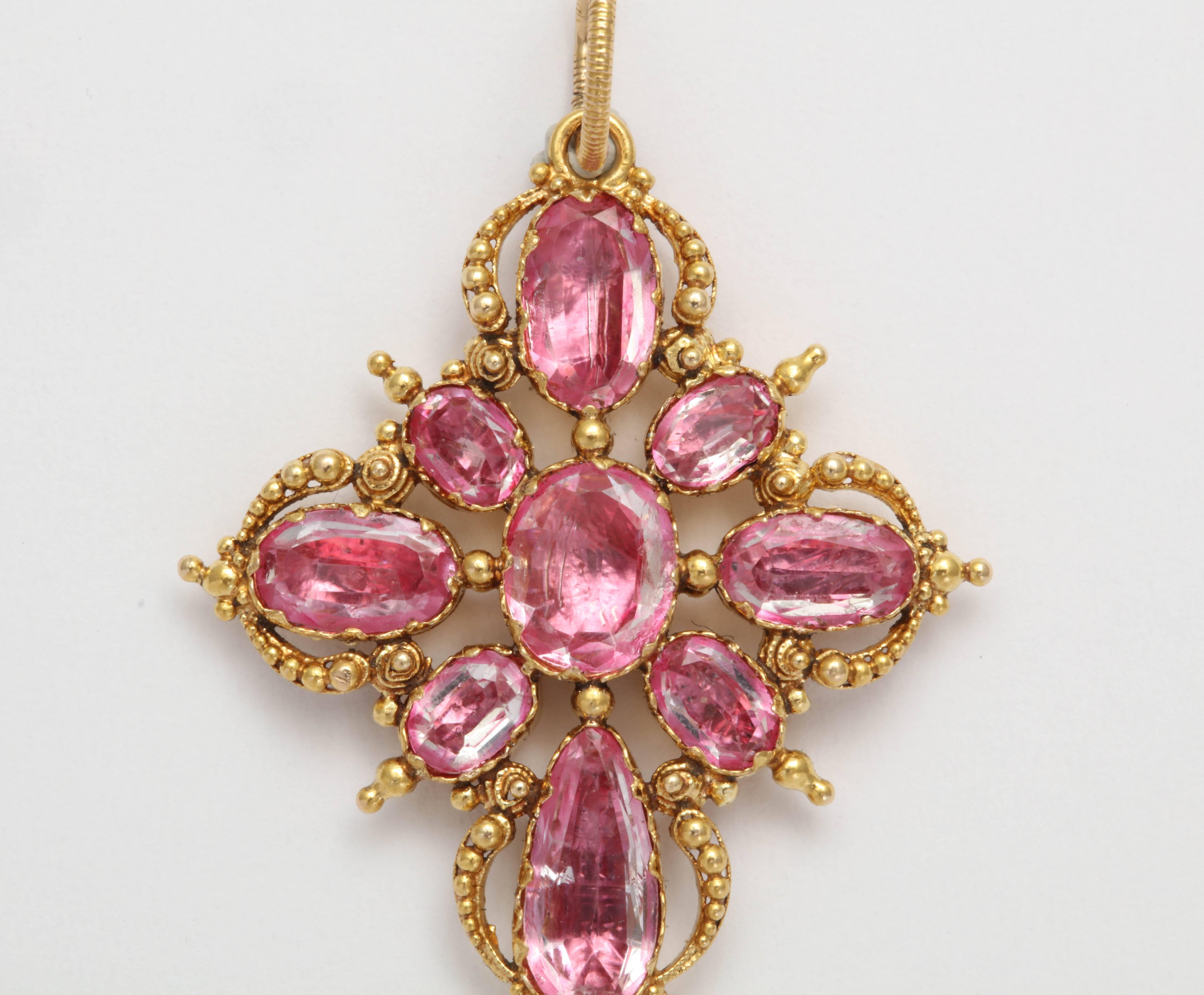 Pink Topaz of the highest quality is set in closed back high carat yellow gold. The stones are very pink and have a lot of life to them. Beaded wire work surrounds the stones. English made in the Georgian era. 