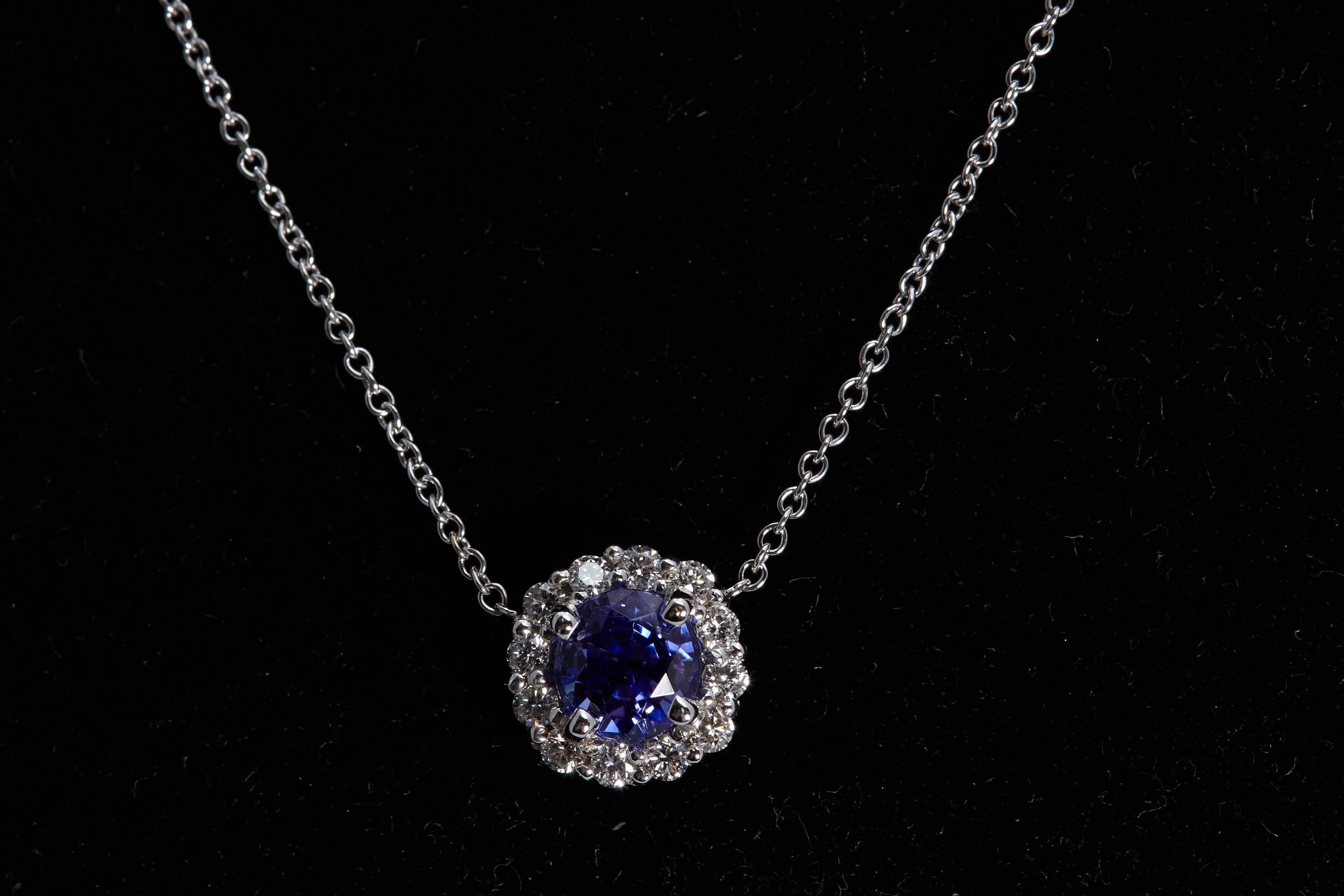 Round tanzanite weighing .99 carat halo pendant with 12 round diamonds weighing .25 carats. The diamonds are 