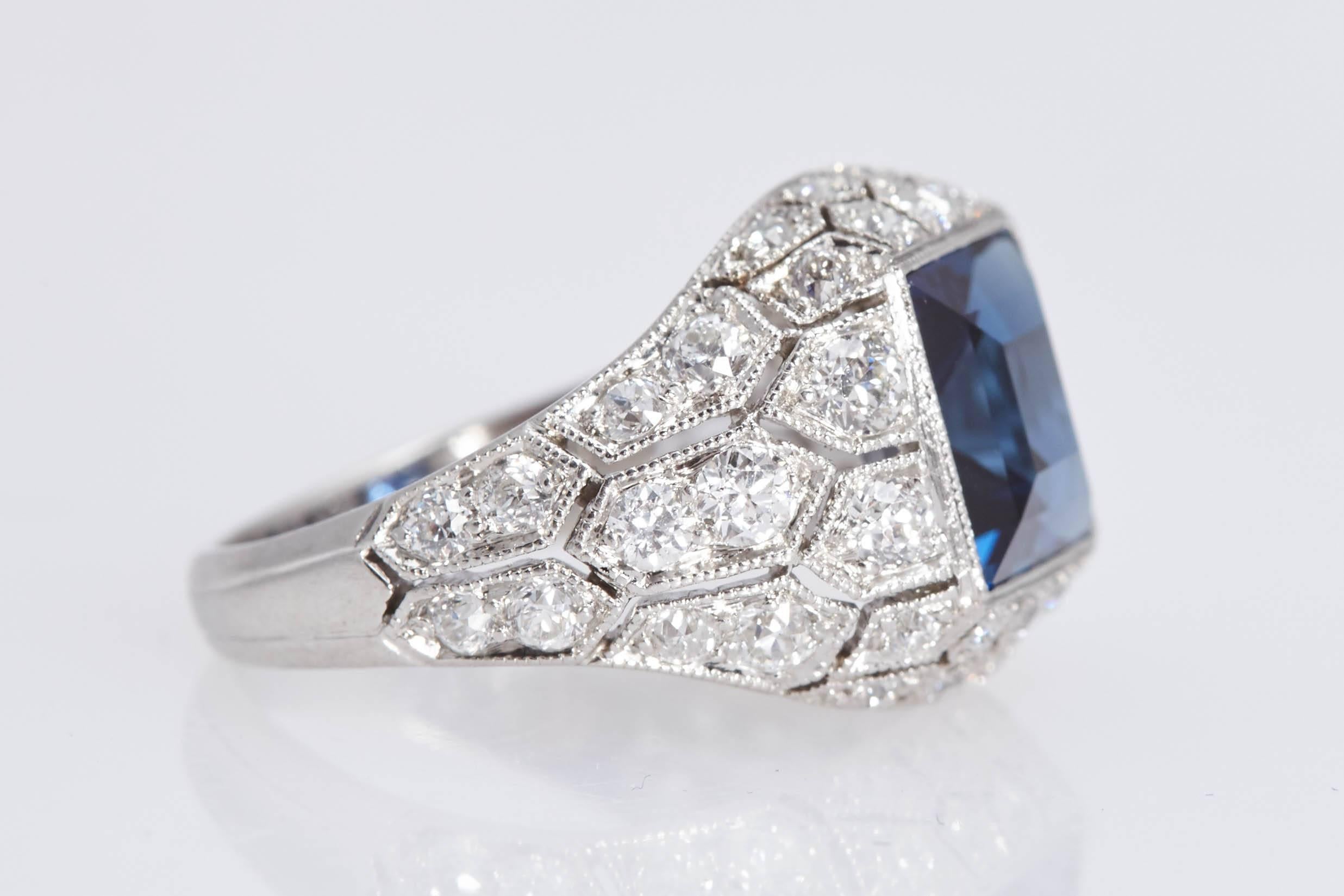 Beautiful Art Deco J.E. Caldwell Sapphire Diamond and Platinum ring. The center blue sapphire is a square shape weighing 2.89 carats and has a certificate from the American Gemological Laboratories. The sapphire is set in a ring with intricate