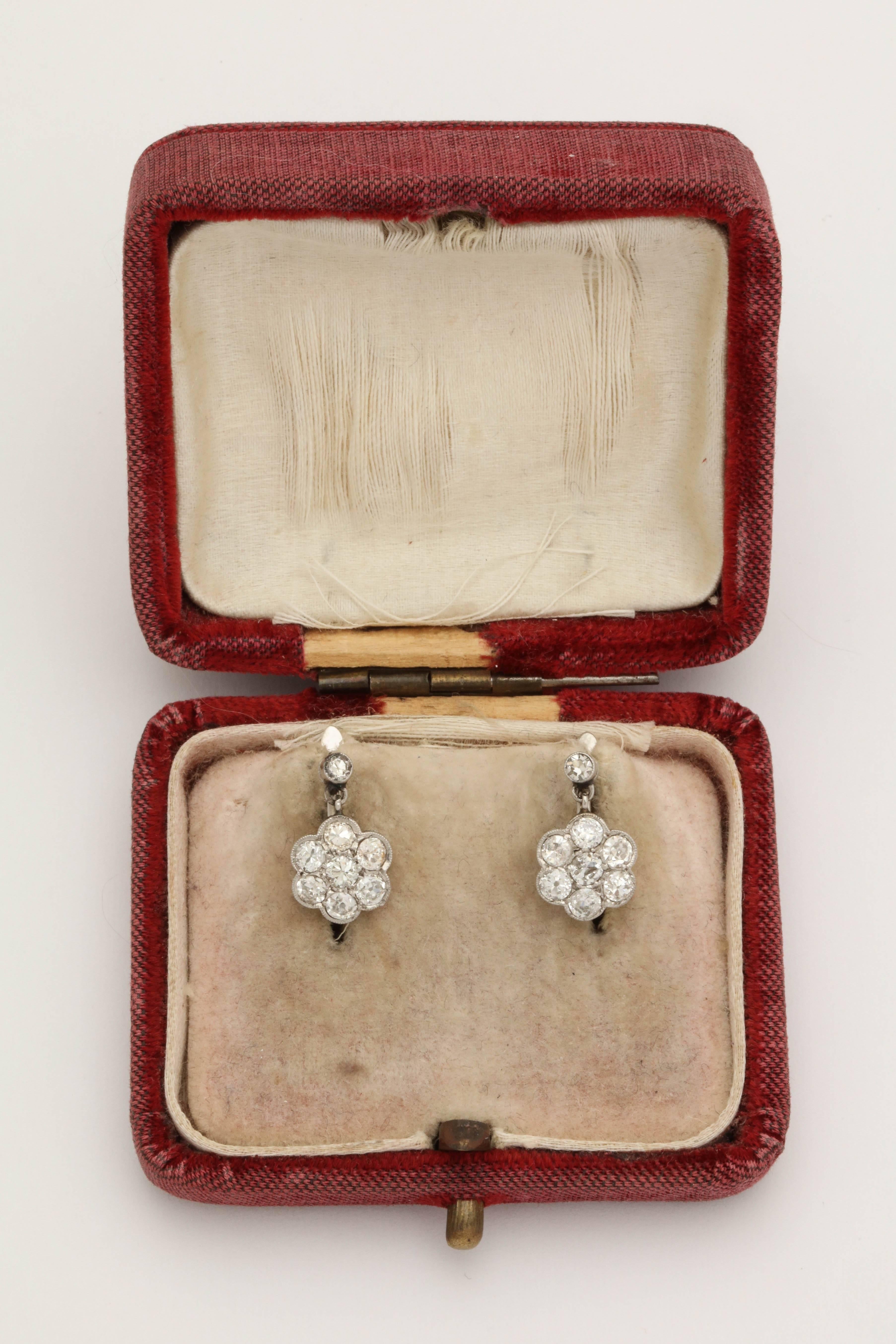 One Pair Of Ladies  Art Deco Delicate Rosetta Design Floral Cluster Diamond Drop earrings Composed Of 16 Antique Cut Diamonds Weighing Approximately 1.50 Cts Total Diamond weight. Earrings Designed With French Back Lever Style Backs For Pierced Ears