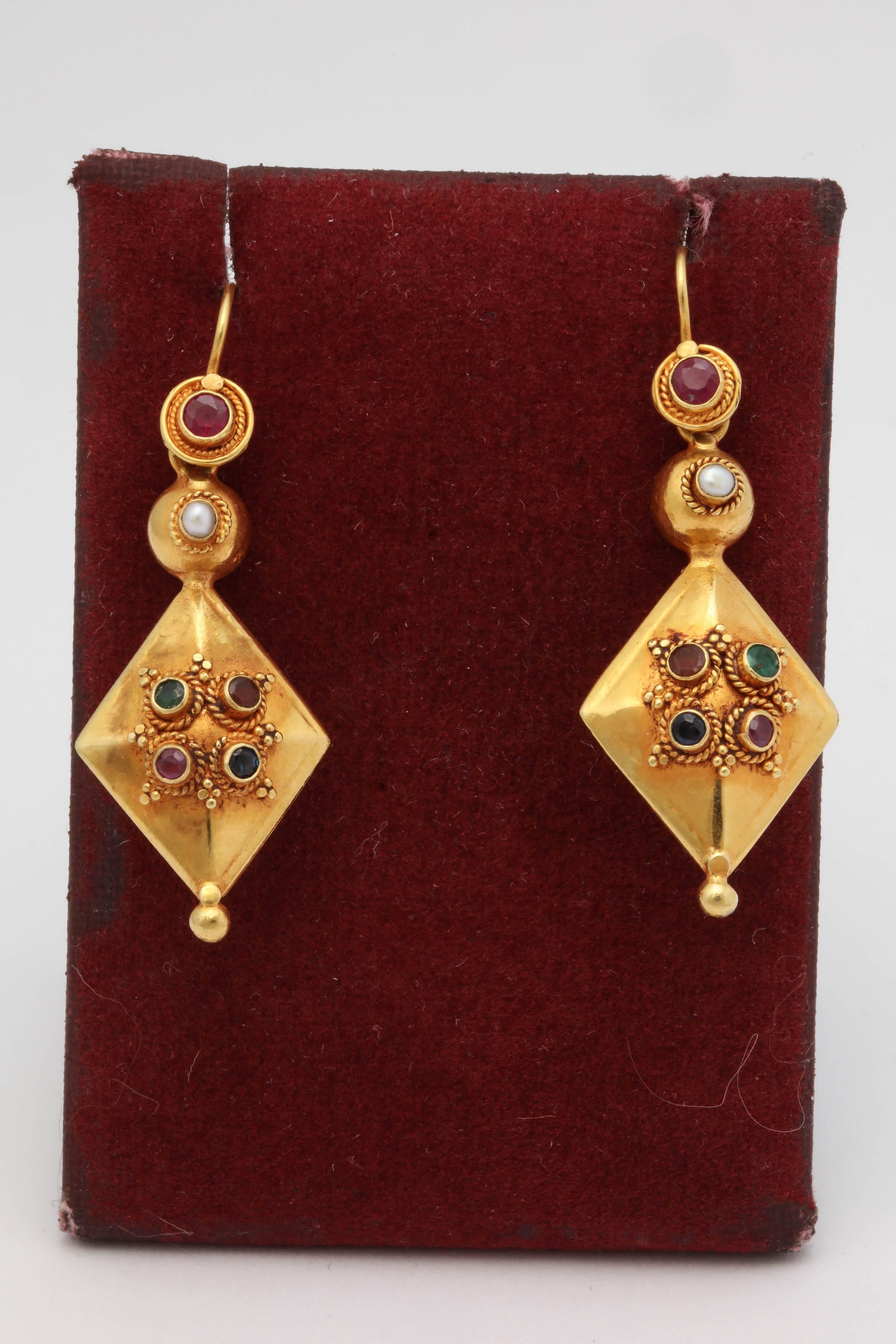 One Pair Of Ladies 22kt Dangle Earrings Exemplifying Beautiful Handmade Twisted Rope Design Detail With The Workmanship Of The Earrings. Earrings Are Further Designed With Six Bezel Set Faceted Rubies And Two Bezel Set Faceted Sapphires With Two