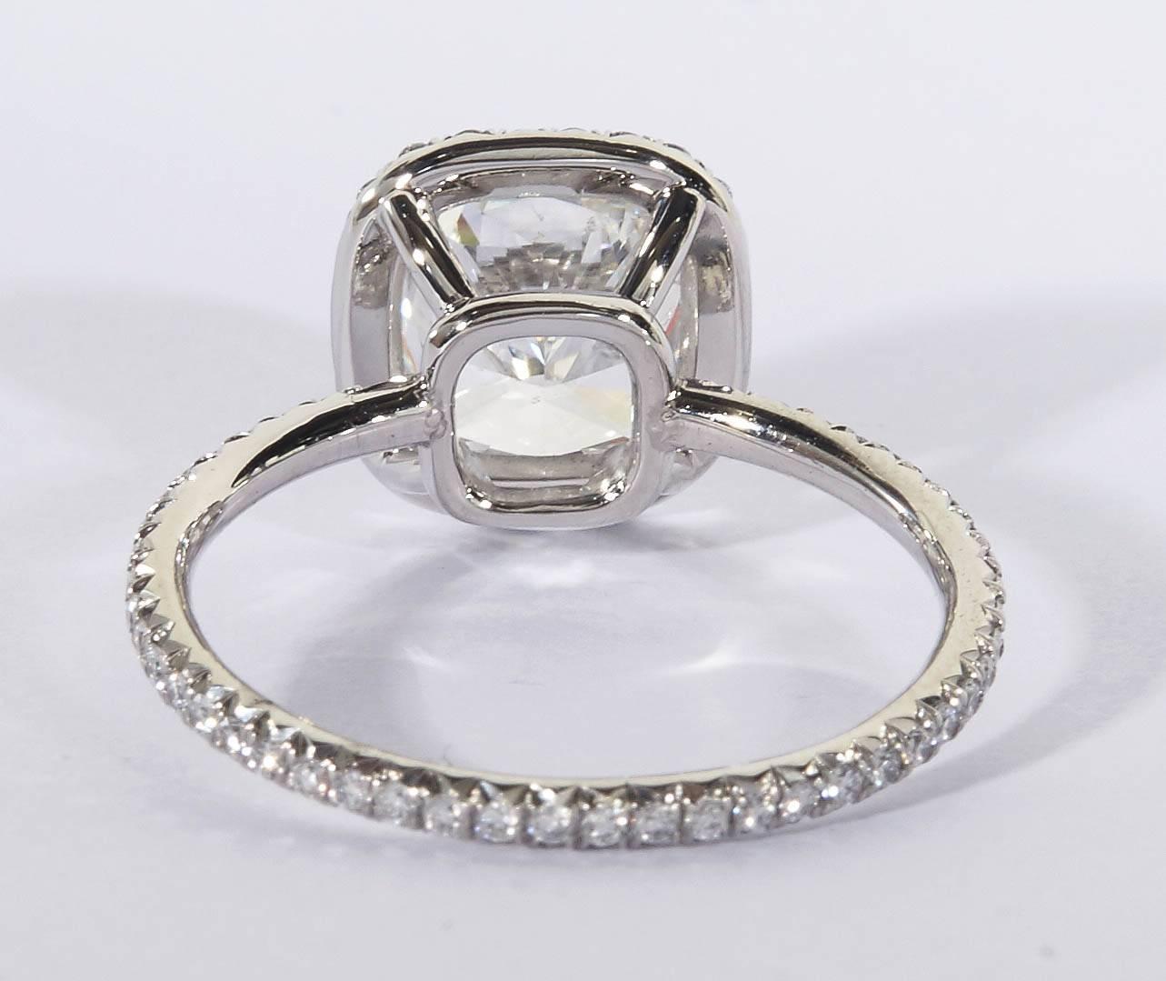 2 carat cushion cut diamond ring on hand
