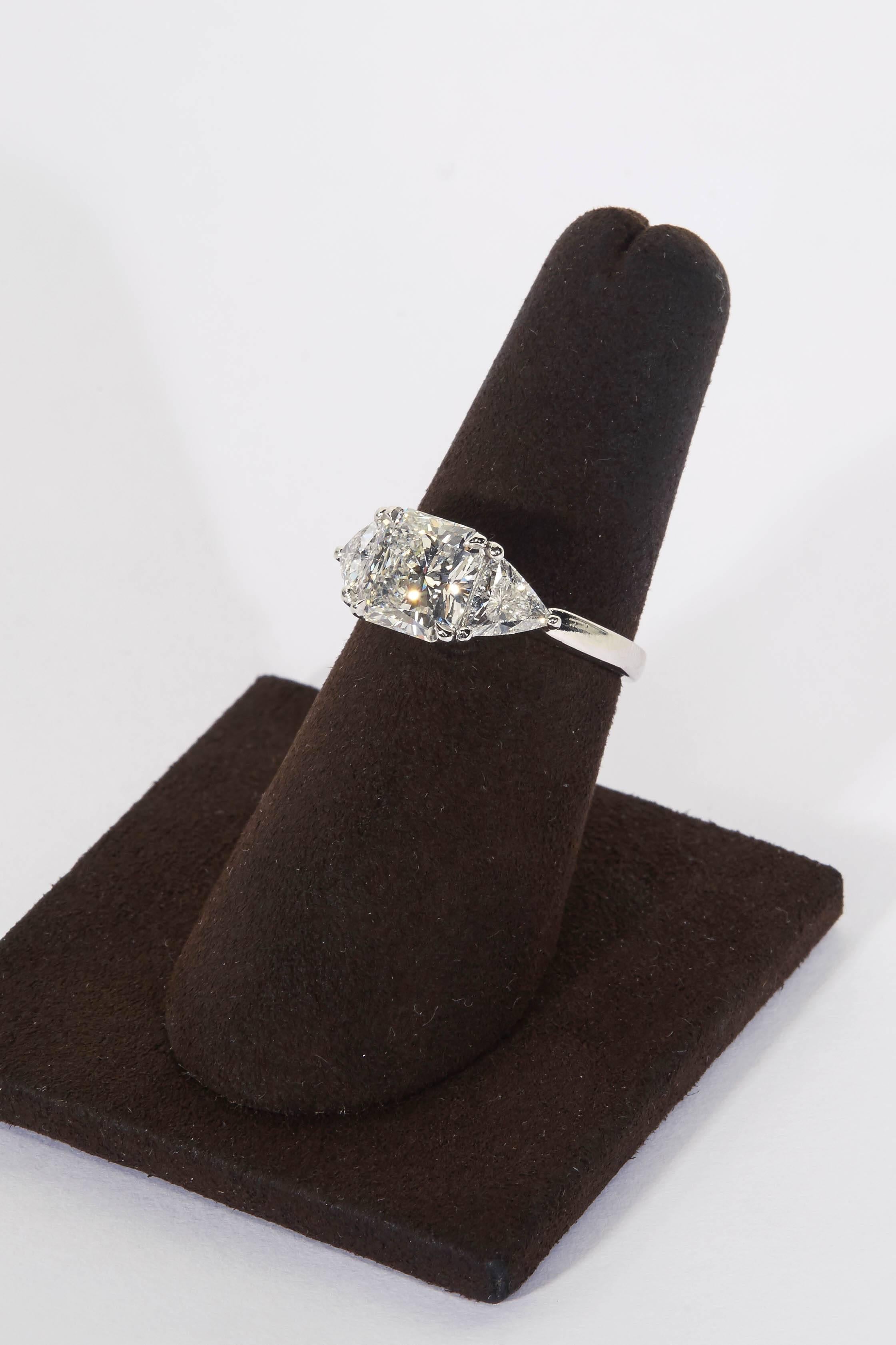 
Radiant cut center diamond set with trillion cut side diamonds. 

2.25 carat GIA certified E color VS1 clarity center diamond set with .80 carats of matching trillion cut diamonds. 

Set in platinum 

The ring is currently a size 6 but can easily