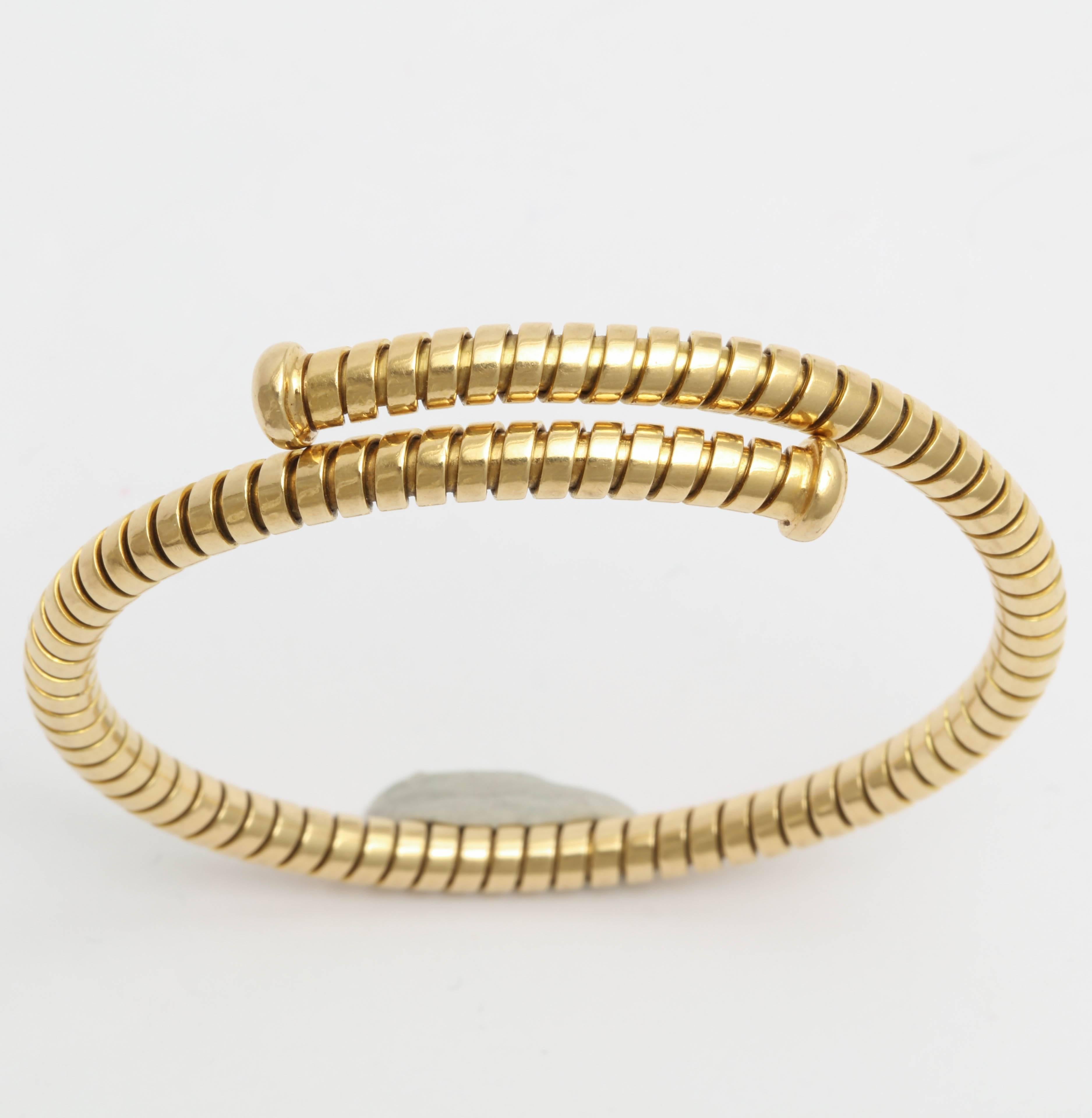 Super chic 18y Yellow Gold Cuff Bangle with nail headed terminals.  Interior Measurements 1.
1.90 wide x 2,15 but expandable. . Signed Bulgari and 750 and bearing an Italian control mark.