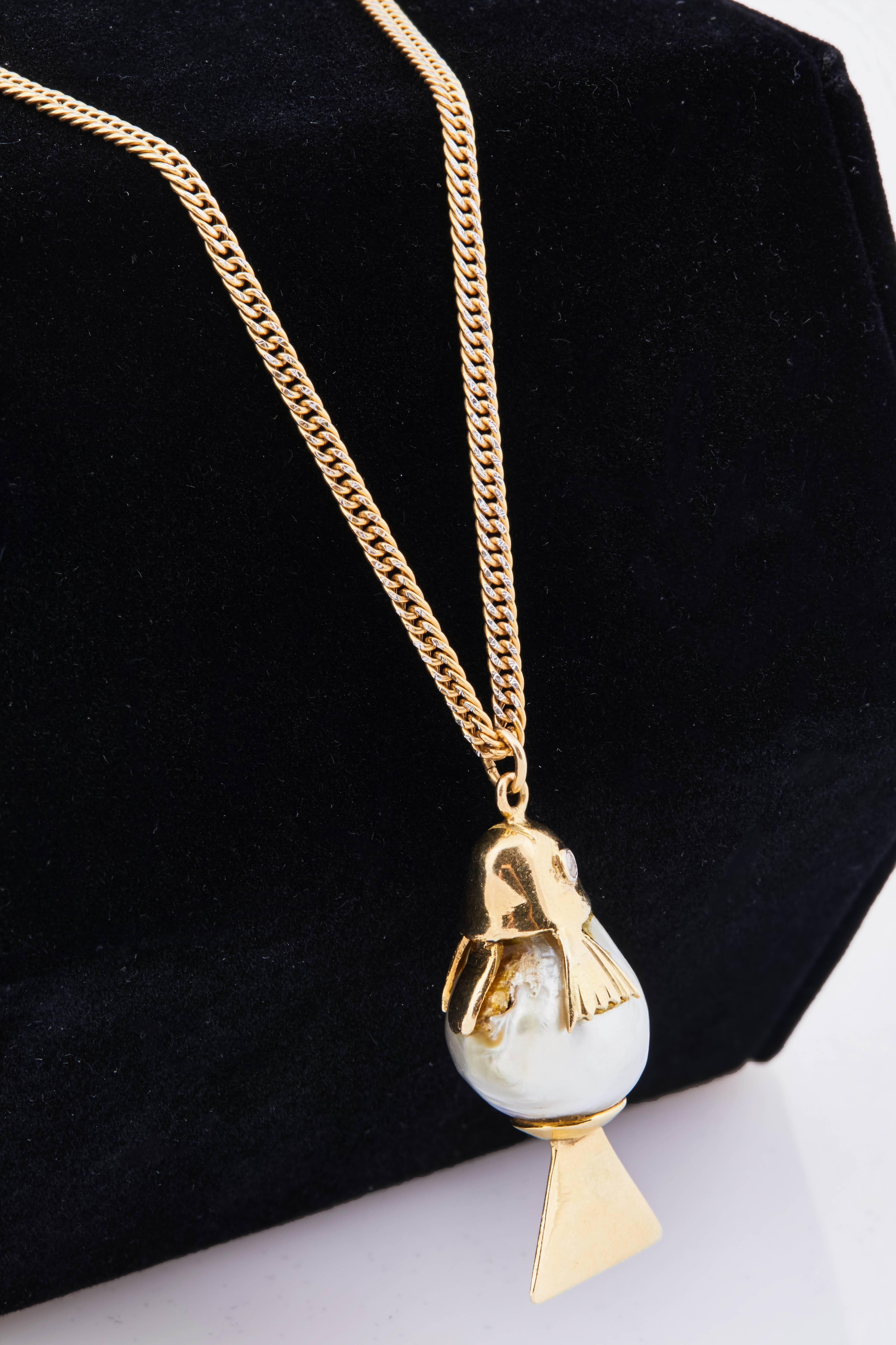 Italian natural pearl, 18k gold and diamond fish charm on 18k gold chain. Chain is 24" long. 