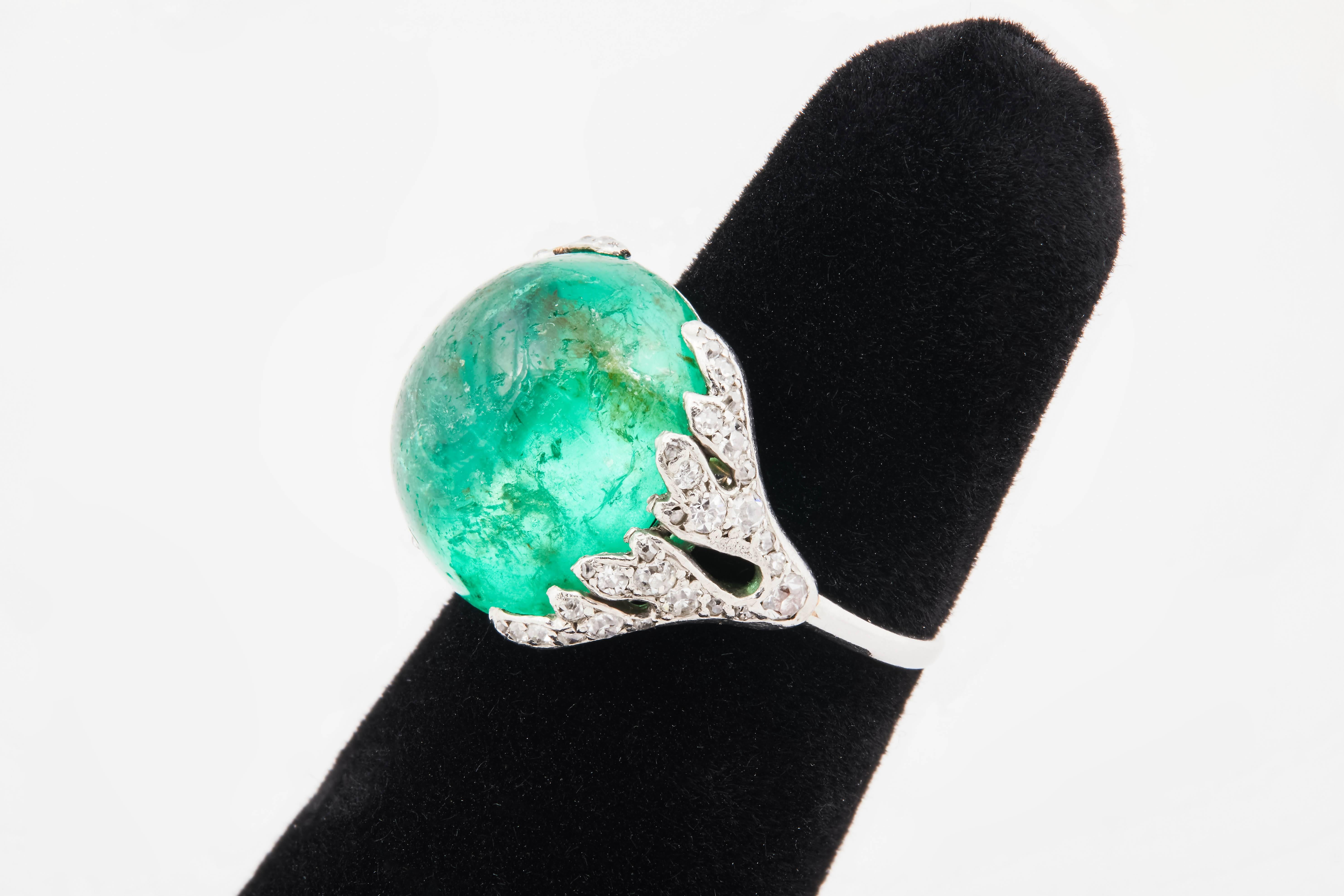 Platinum ring with 14.6ct cabochon emerald and 46 round, single-cut diamonds weighting approximately 9.50ct. Circa 1920s. Size 5.5.