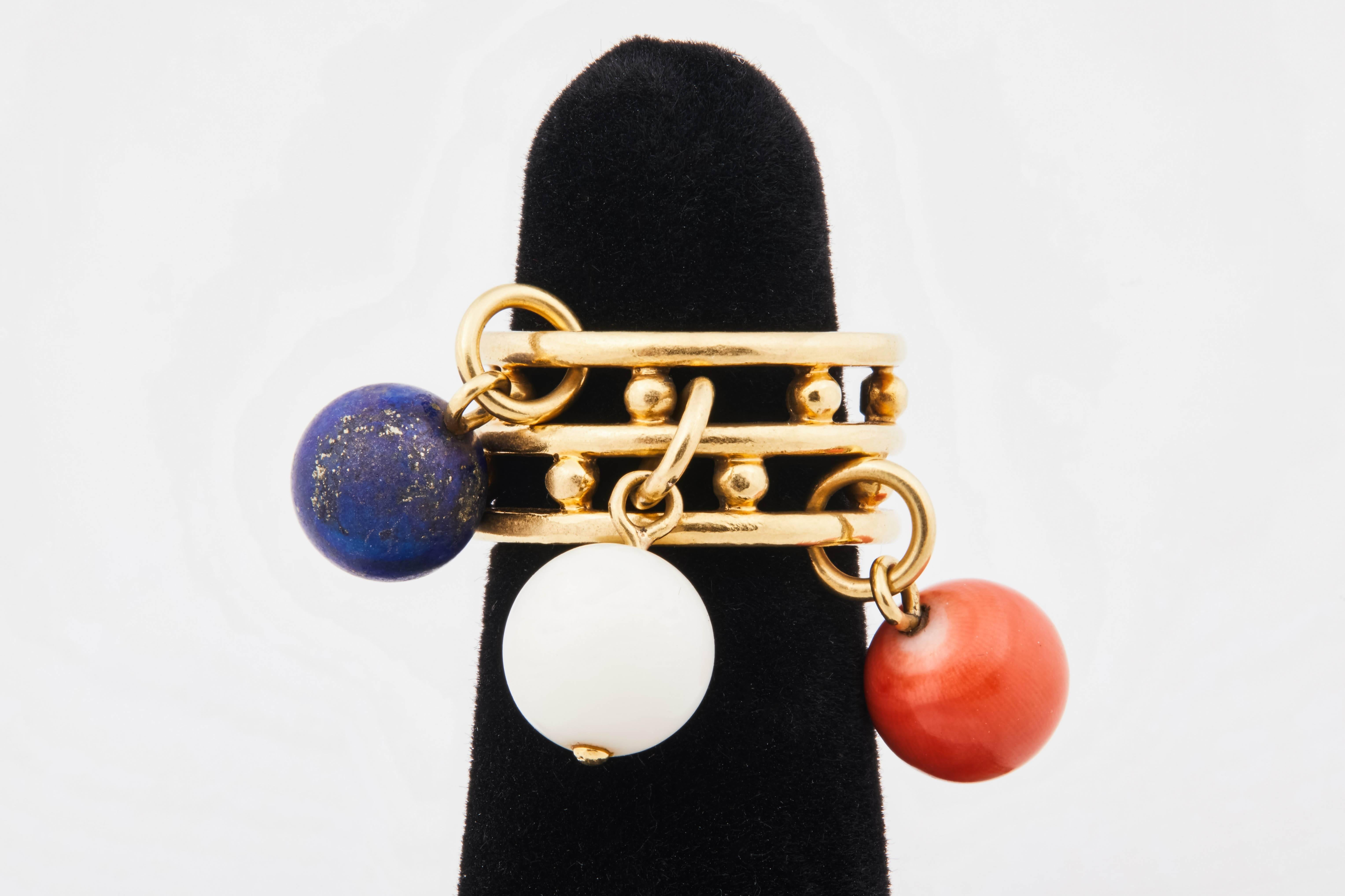 Playful 1970s French 18k gold ring with stacked bands and coral and lapis beads. Beads are approx 9mm diameter.  Band is approx 10mm thick. Size 5.