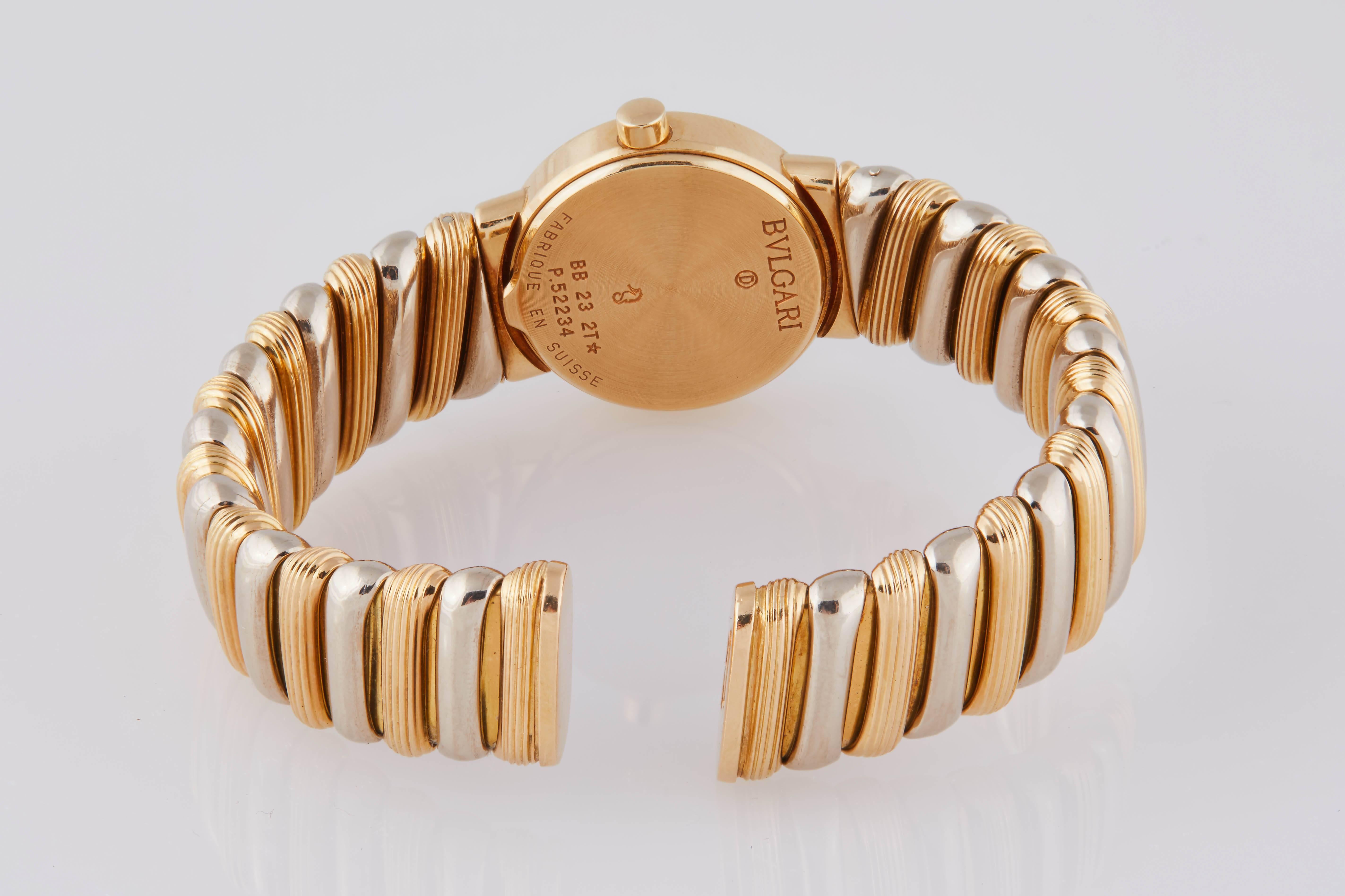 Bulgari Tubogas women's 18k yellow and white gold cuff bracelet watch, c. 1980. Sapphire crystal, logo engraved bezel, black flat dial. 