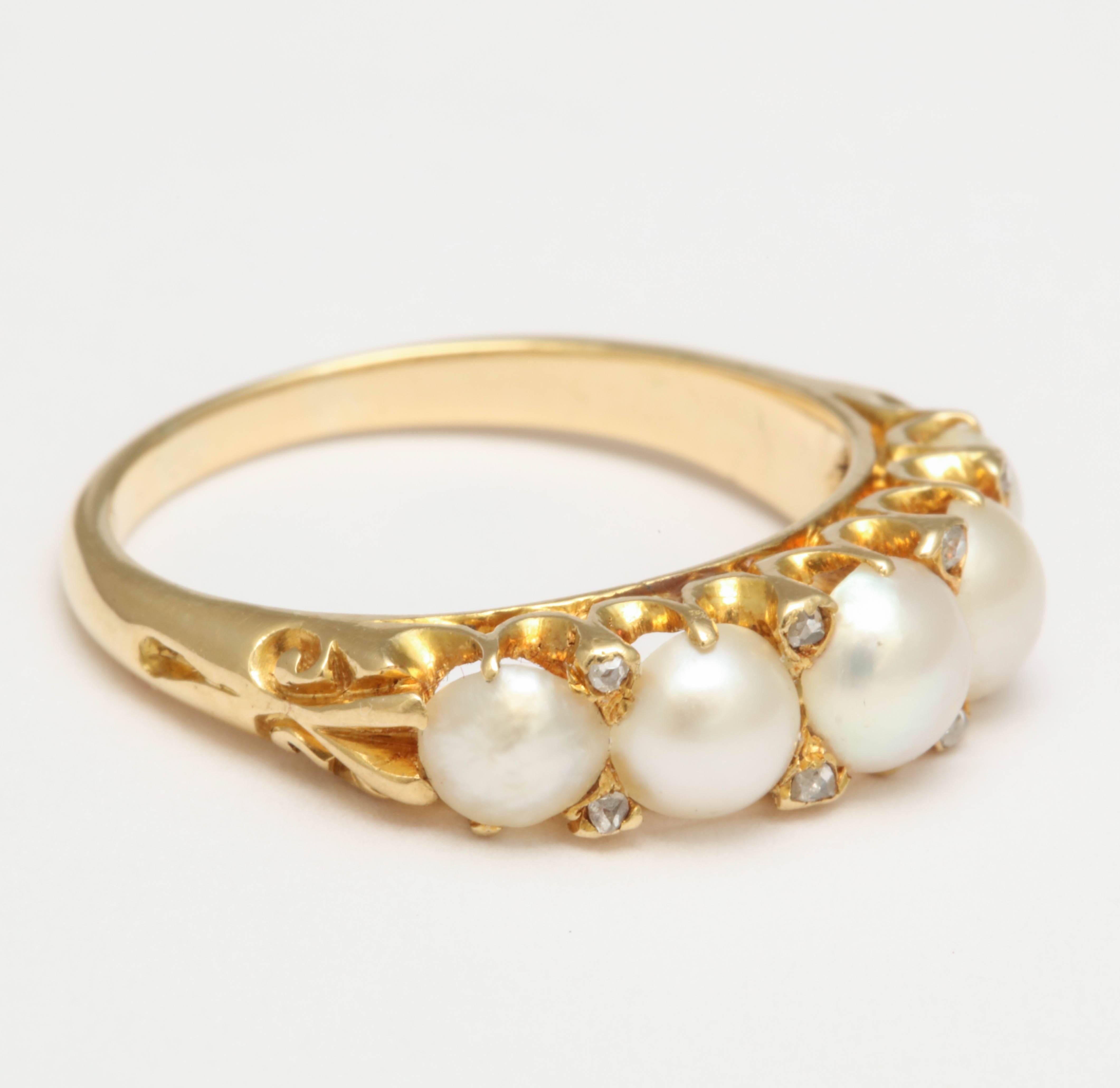 A Victorian five half pearl and with 8 rose cut diamond yellow gold ring. Engraving on the shoulders. 