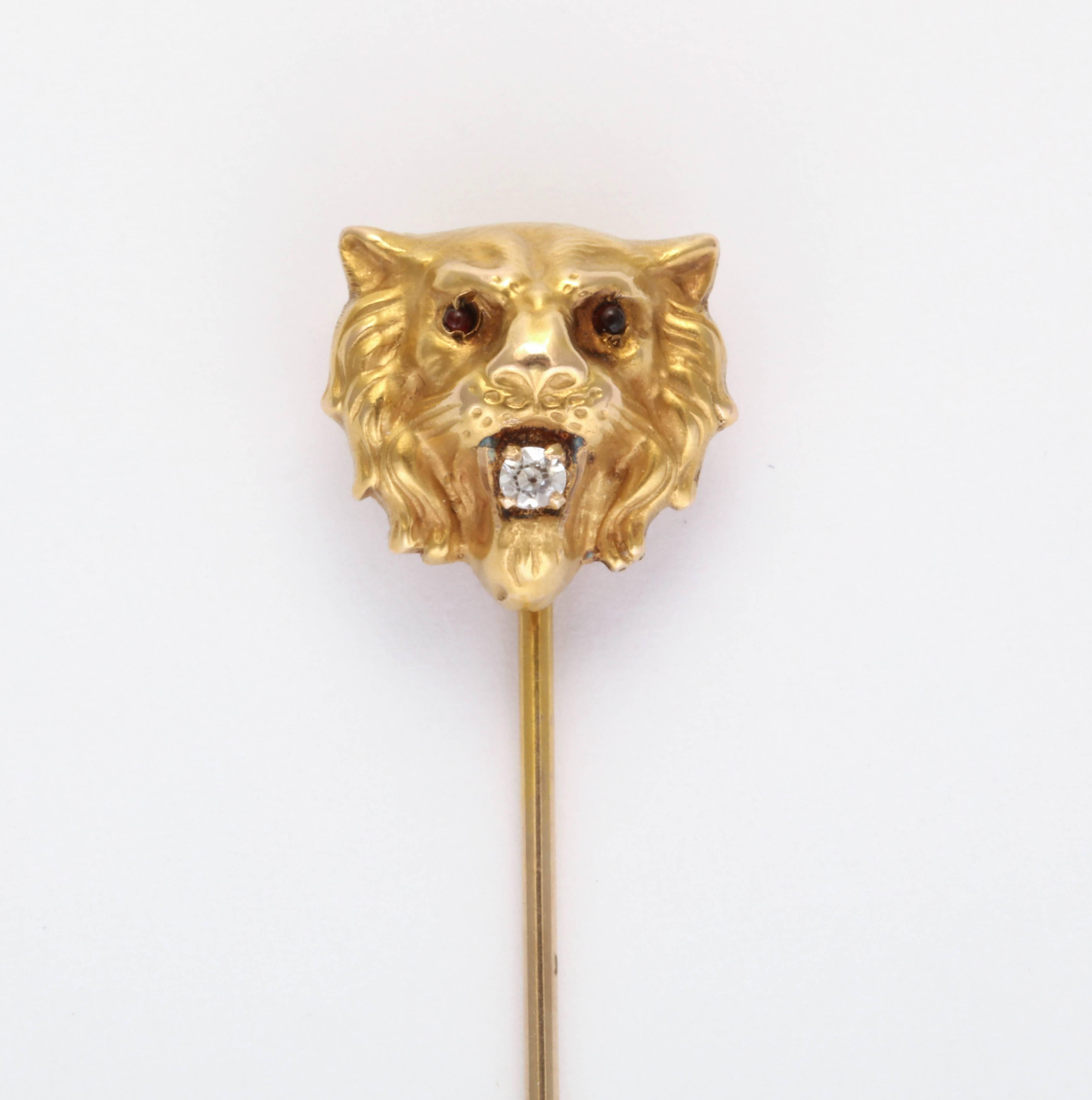 Lion Stickpin. Eyes set with cabochon garnets and mouth set with a small old cut diamond. 