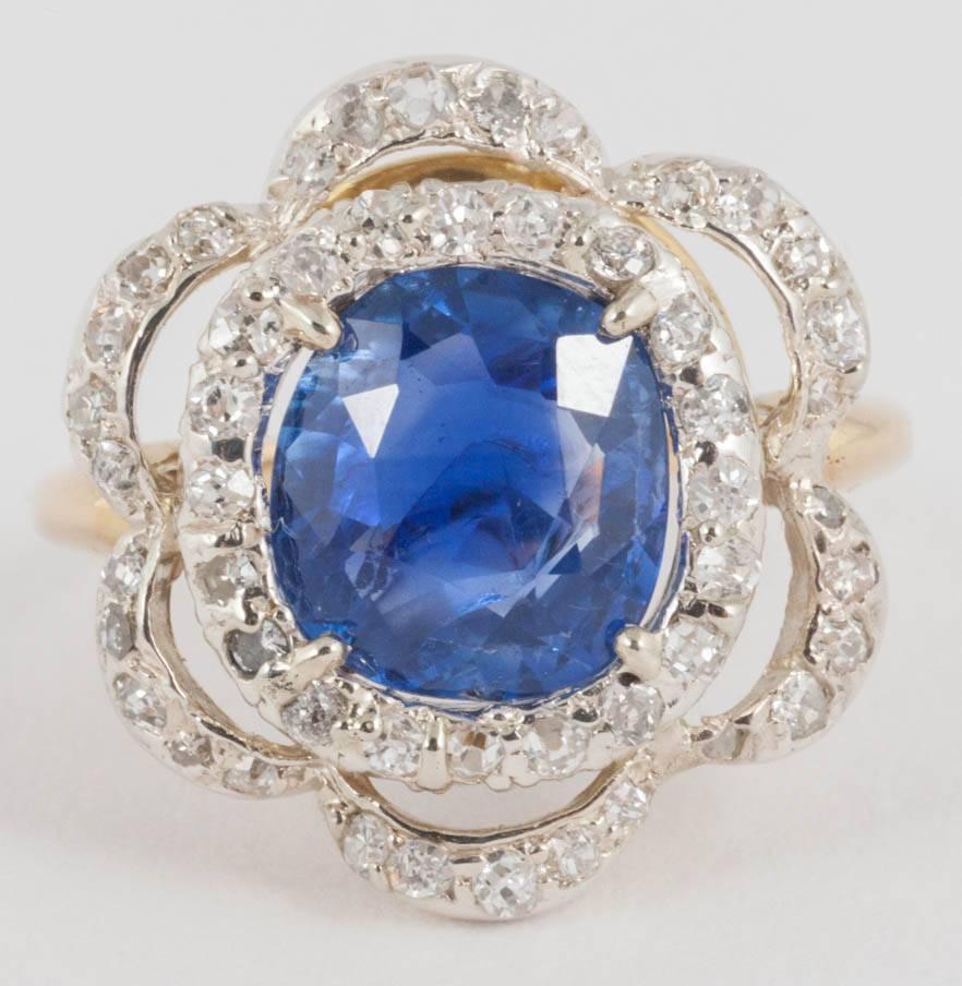 Natural 3.85ct Ceylon Sapphire ring surrounded by intertwining 2 rows of small Diamonds and set in Platinum and 18ct Gold
Finger size M