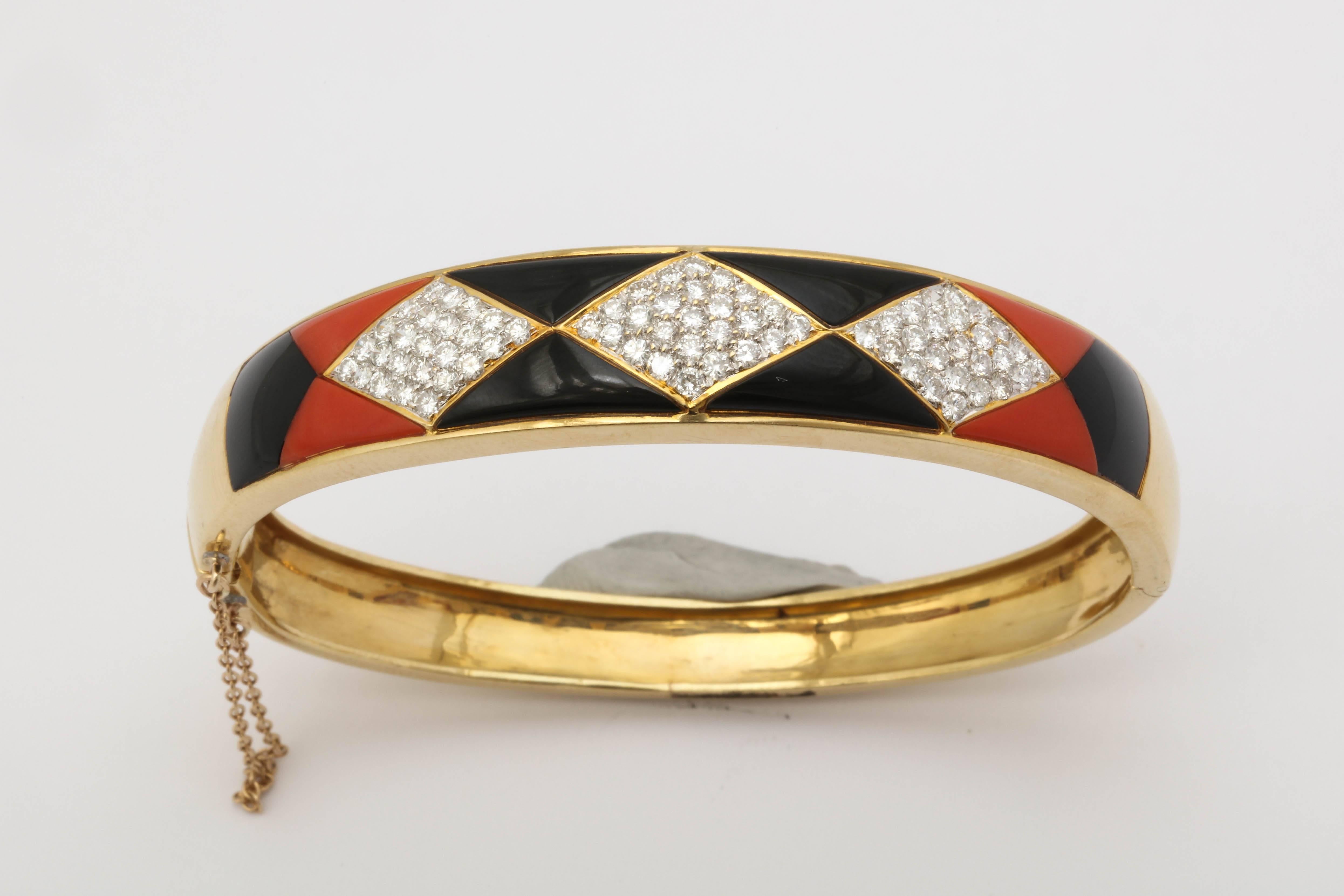 One Ladies Bangle Bracelet Crafted In 18kt Yellow Gold Designed With Alternating Custom Cut Onyx And Coral Asymmetrical Triangular Cut Panels. Further Embellished With Three Horizonal Marquise Panels Encrusted With Approximately 3.75 Cts Of High